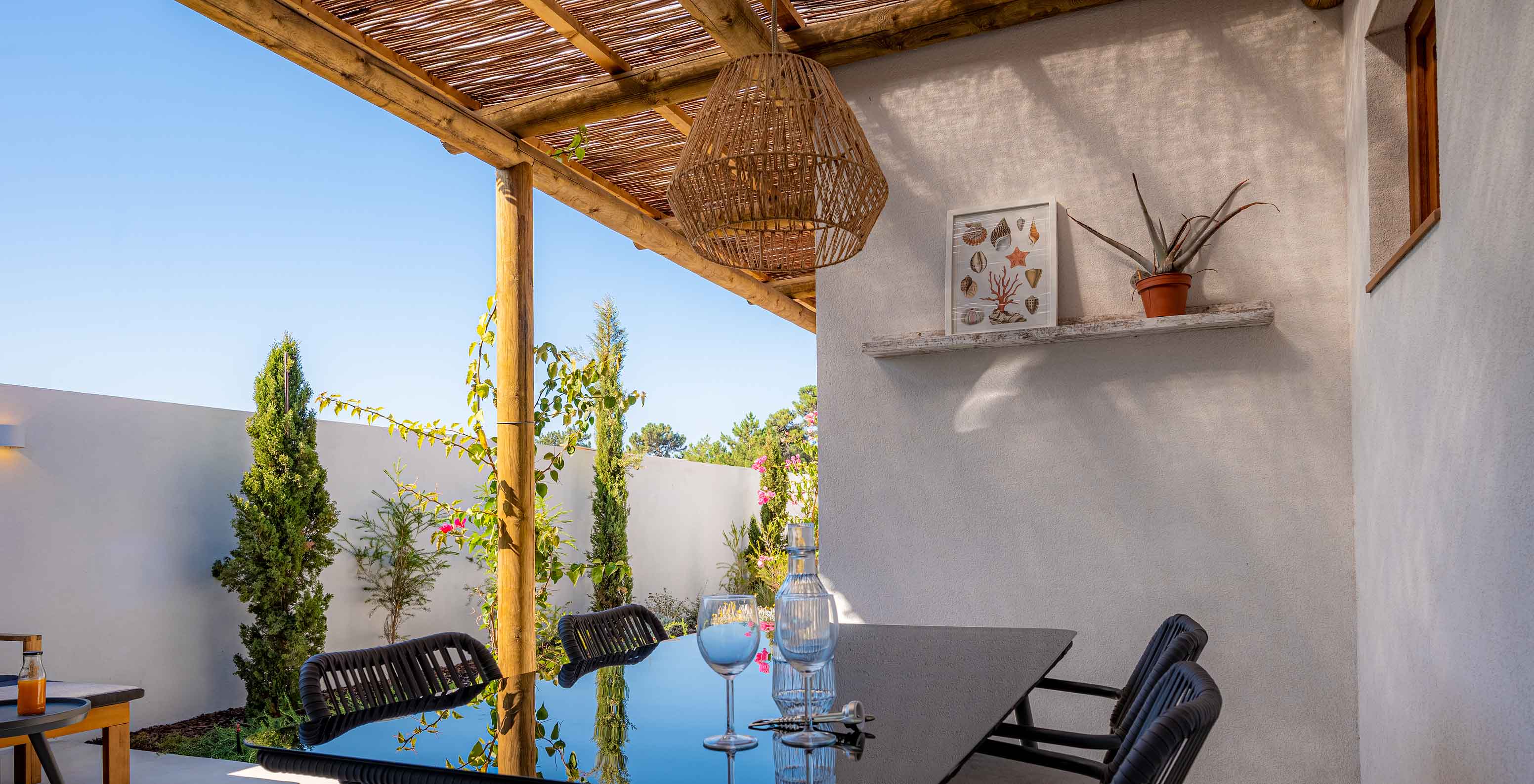 Die Standard Villa T2 im Pestana Comporta Village Residences verfügt über einen Außenspeisetisch unter einer Pergola
