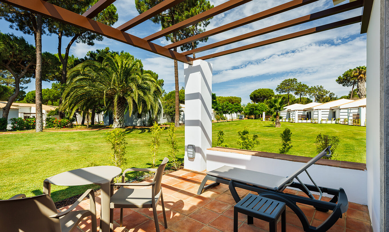 Das Family Garden View im Pestana Vila Sol - Vilamoura hat Balkon mit Liegestuhl, Tisch und Gartenblick