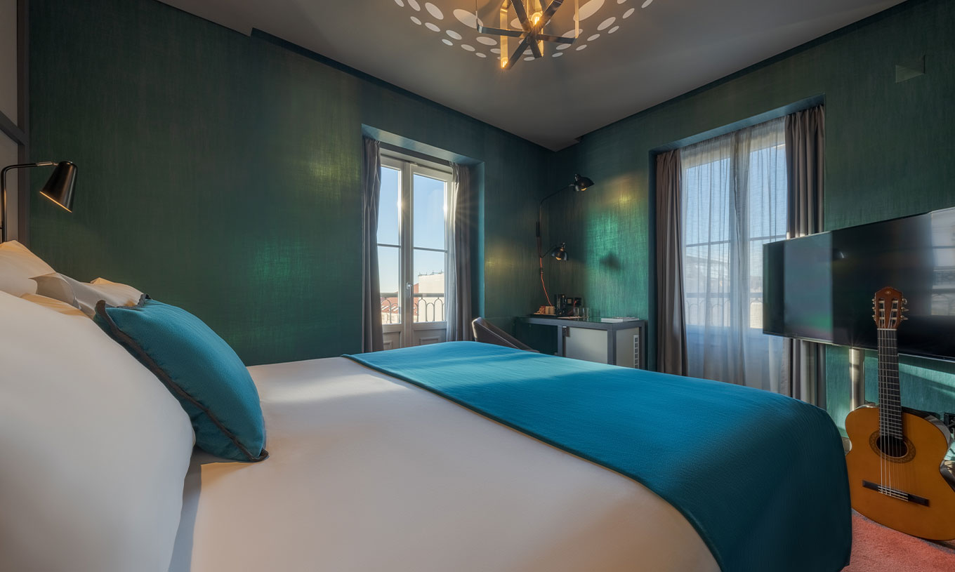 Das CR7 Superior Corner im Pestana CR7 Lisboa hat ein Bett und zwei Fenster mit Blick auf das historische Zentrum