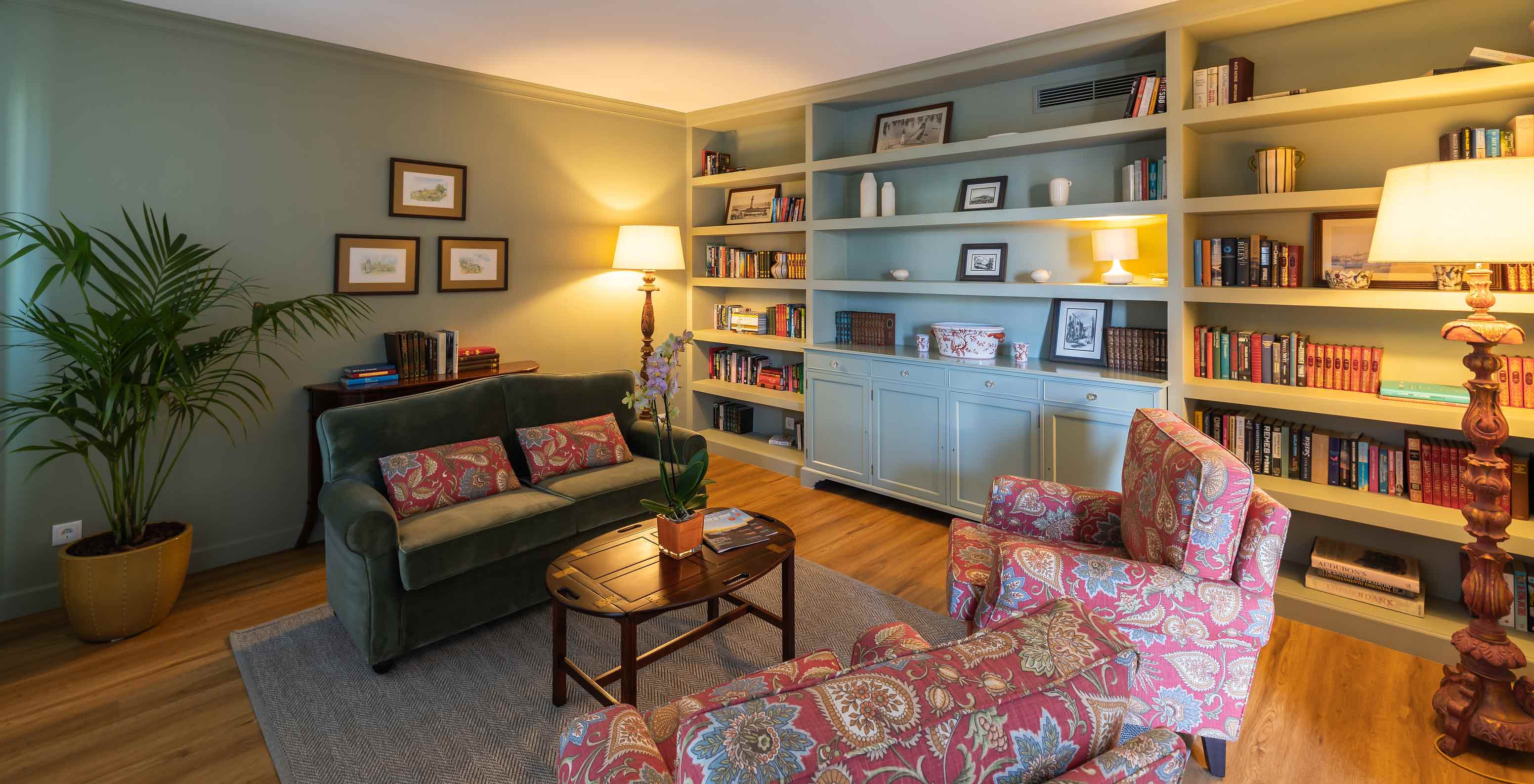 Bibliothek des Pestana Quinta Perestrello mit Sofa, Bücherregal, Pflanze und Stehlampe