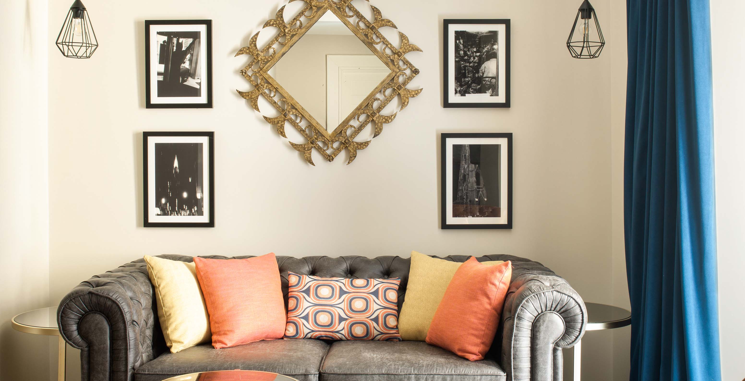 Das Deluxe Grand Plaza Mayor im  Klassisches Zimmer - Kaffee - Pestana Collection Plaza Mayor hat ein graues Zweisitzer-Sofa und Bilder an der Wand