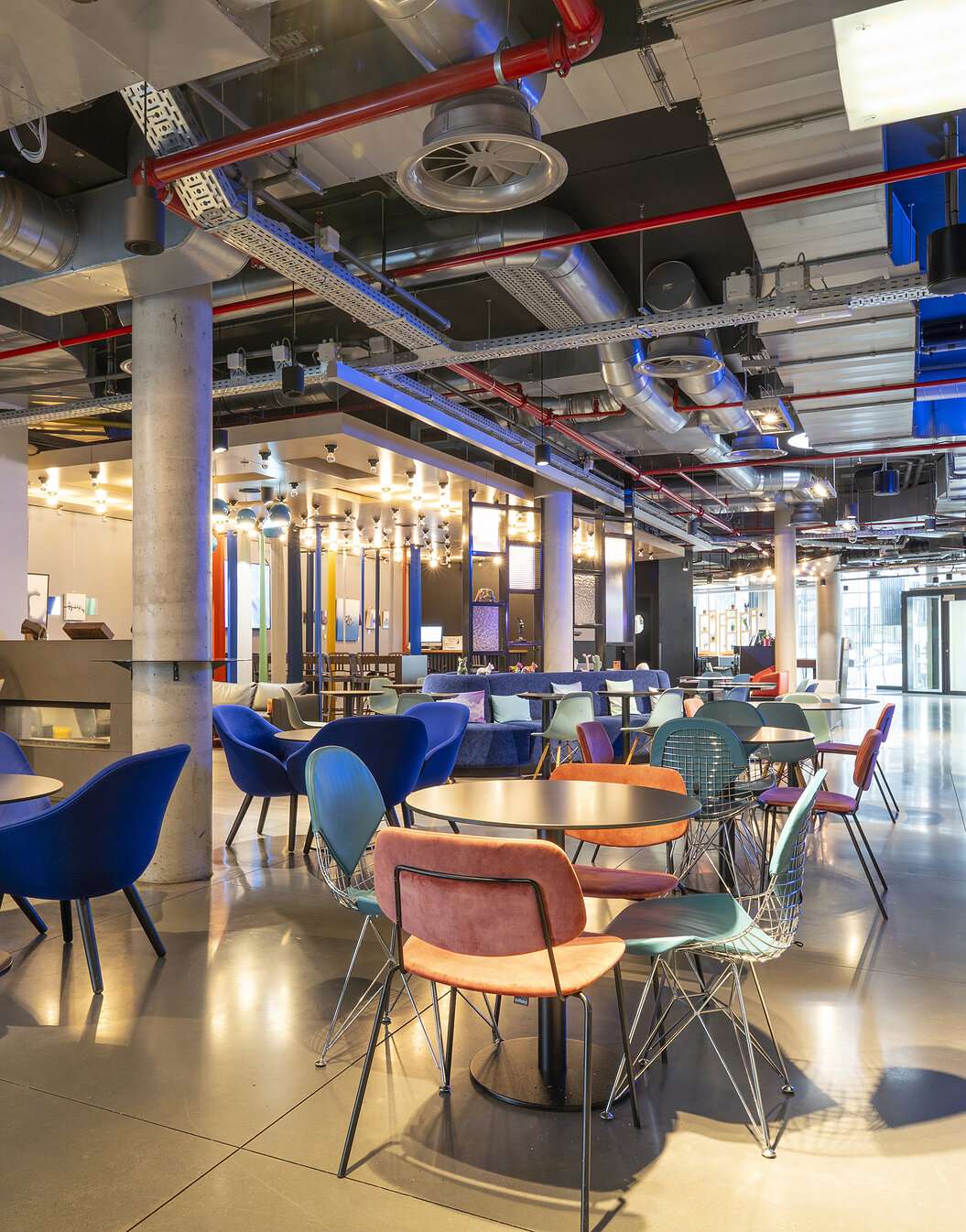 Tables and chairs from the bar and entrance of Pestana Brussels Schuman, a hotel in Brussels, Belgium