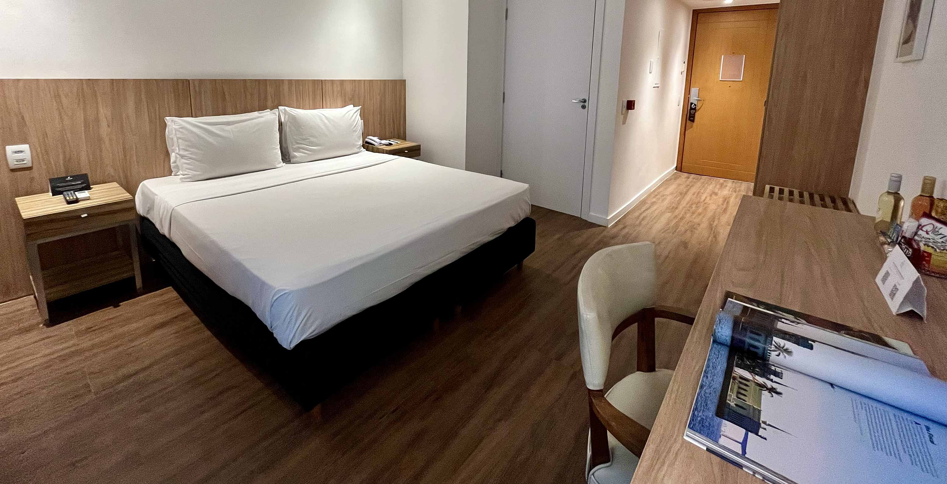 The Semi-Adapted Room at Pestana Rio Atlântica has a bed, desk, wall TV and wooden floor