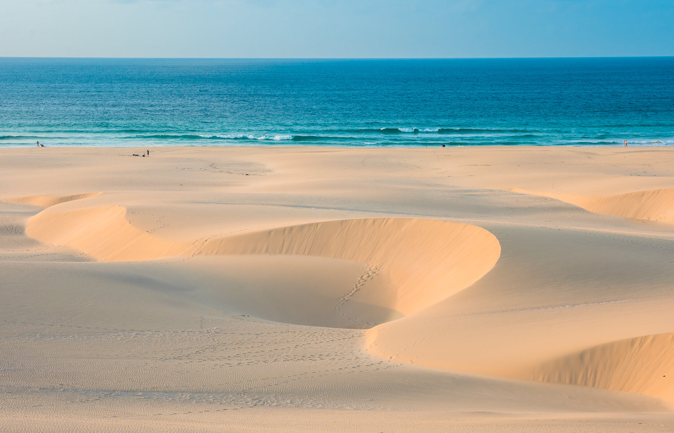 Panoramic view of Chaves Beach with wind-sculpted sand dunes contrasting with turquoise blue sea