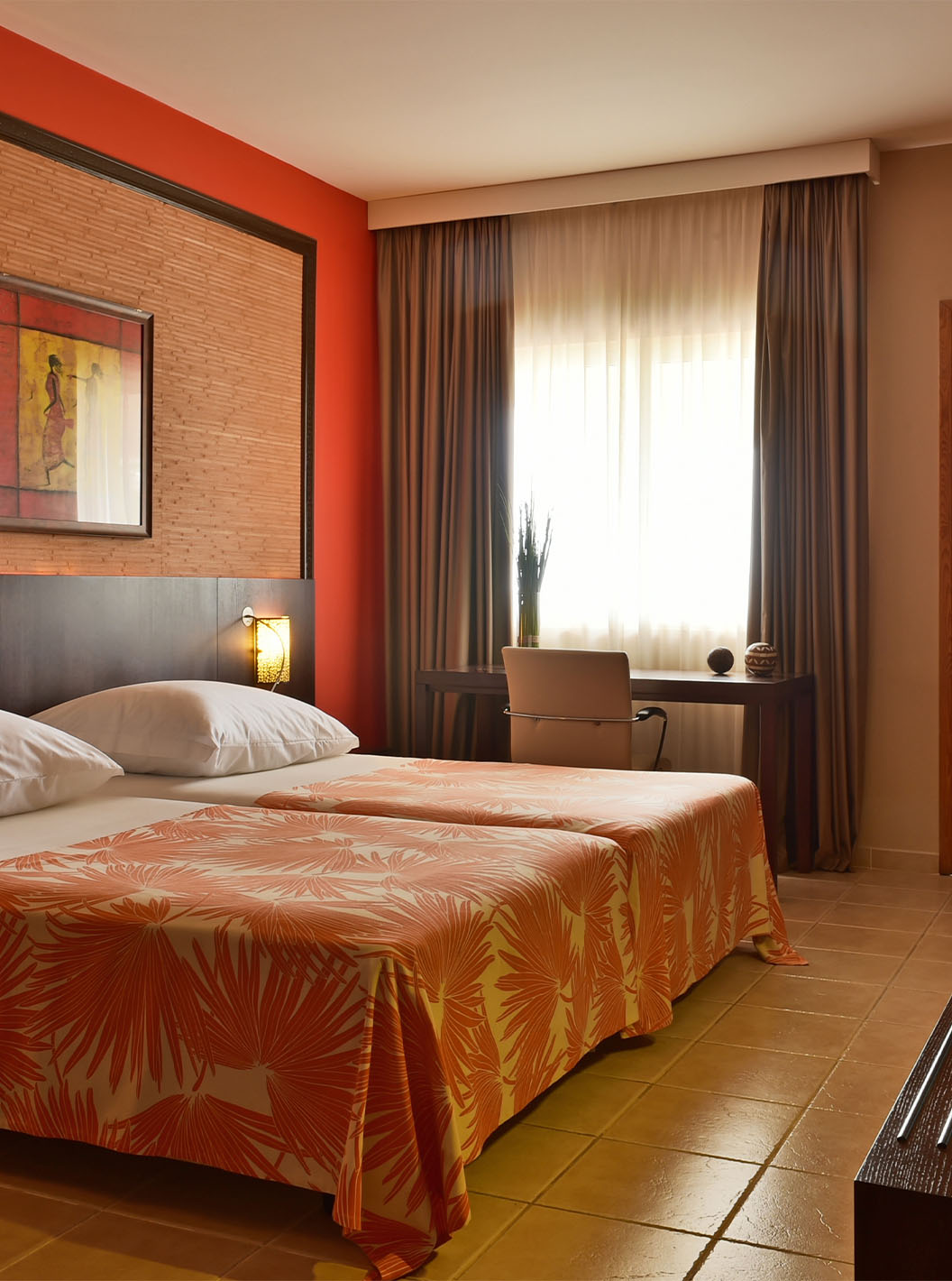 The Premium room at Pestana Tropico features two single beds, television, and desk with chair