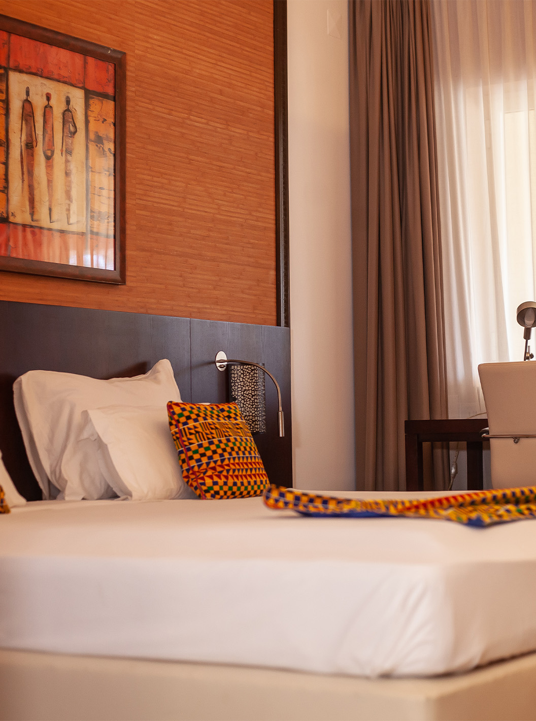 The Premium room at Pestana Tropico features a double bed, desk, and artistic walls