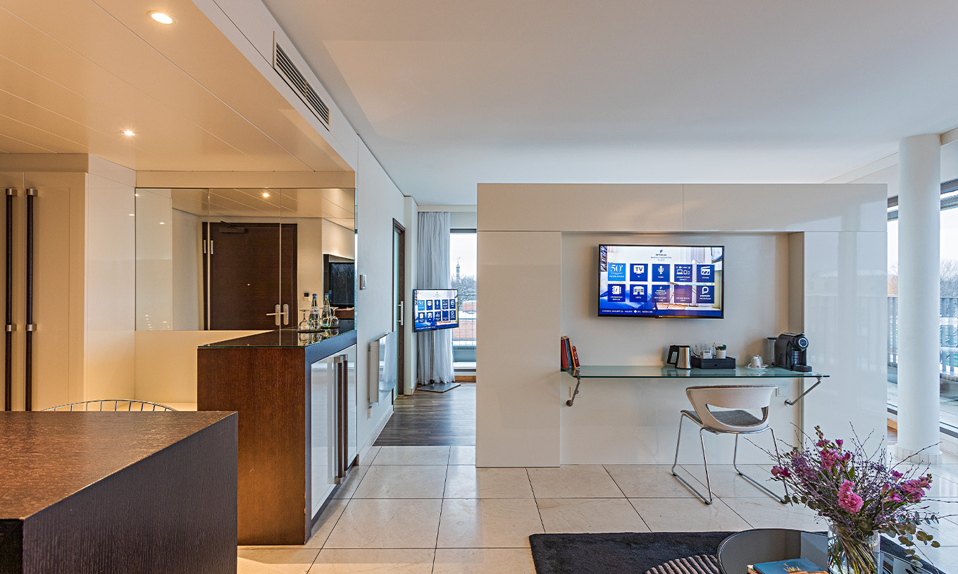 Panoramic Suite at Pestana Berlin Tiergarten has a desk with chair, TV and coffee machine