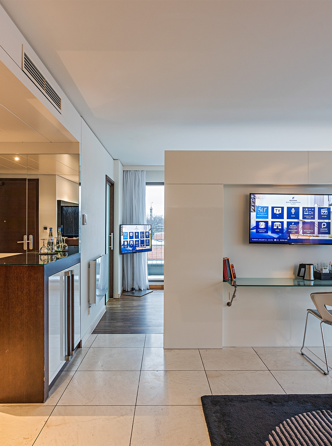 Panoramic Suite at Pestana Berlin Tiergarten has a desk with chair, TV and coffee machine