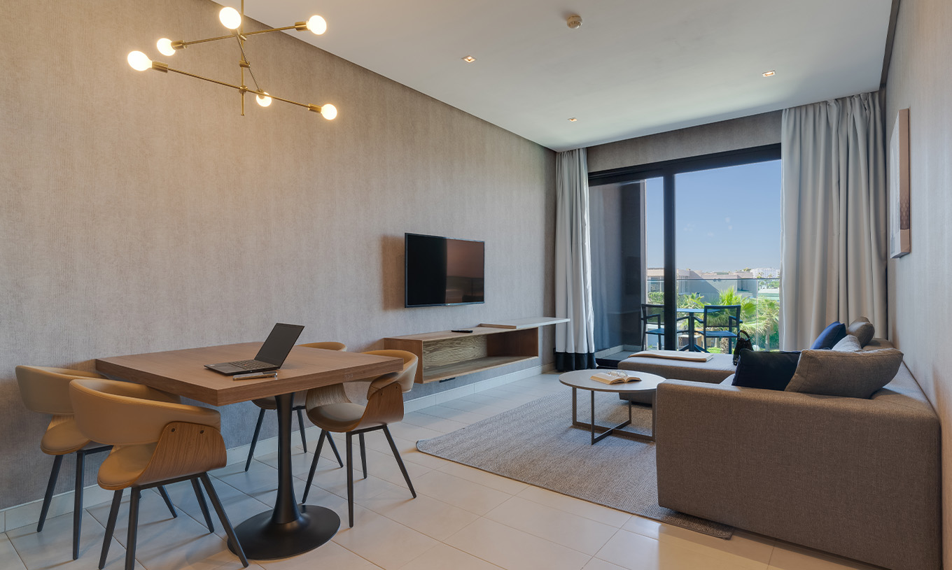 The Premium Suite at Pestana Casablanca has a living room with a sofa and TV and a balcony to enjoy the view