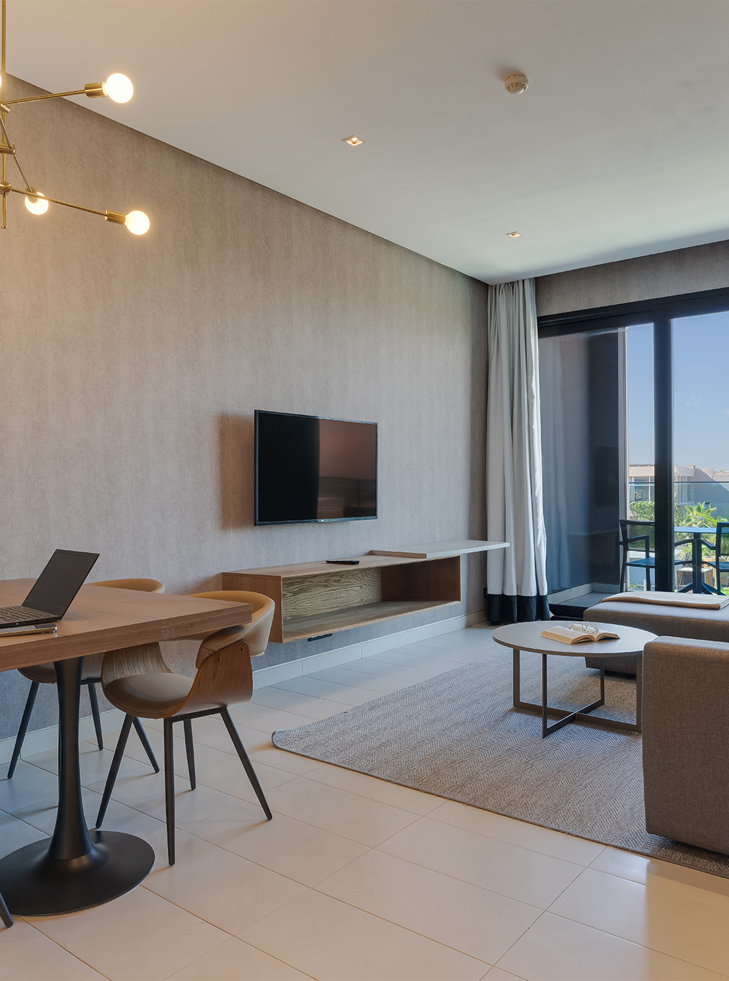 The Premium Suite at Pestana Casablanca has a living room with a sofa and TV and a balcony to enjoy the view