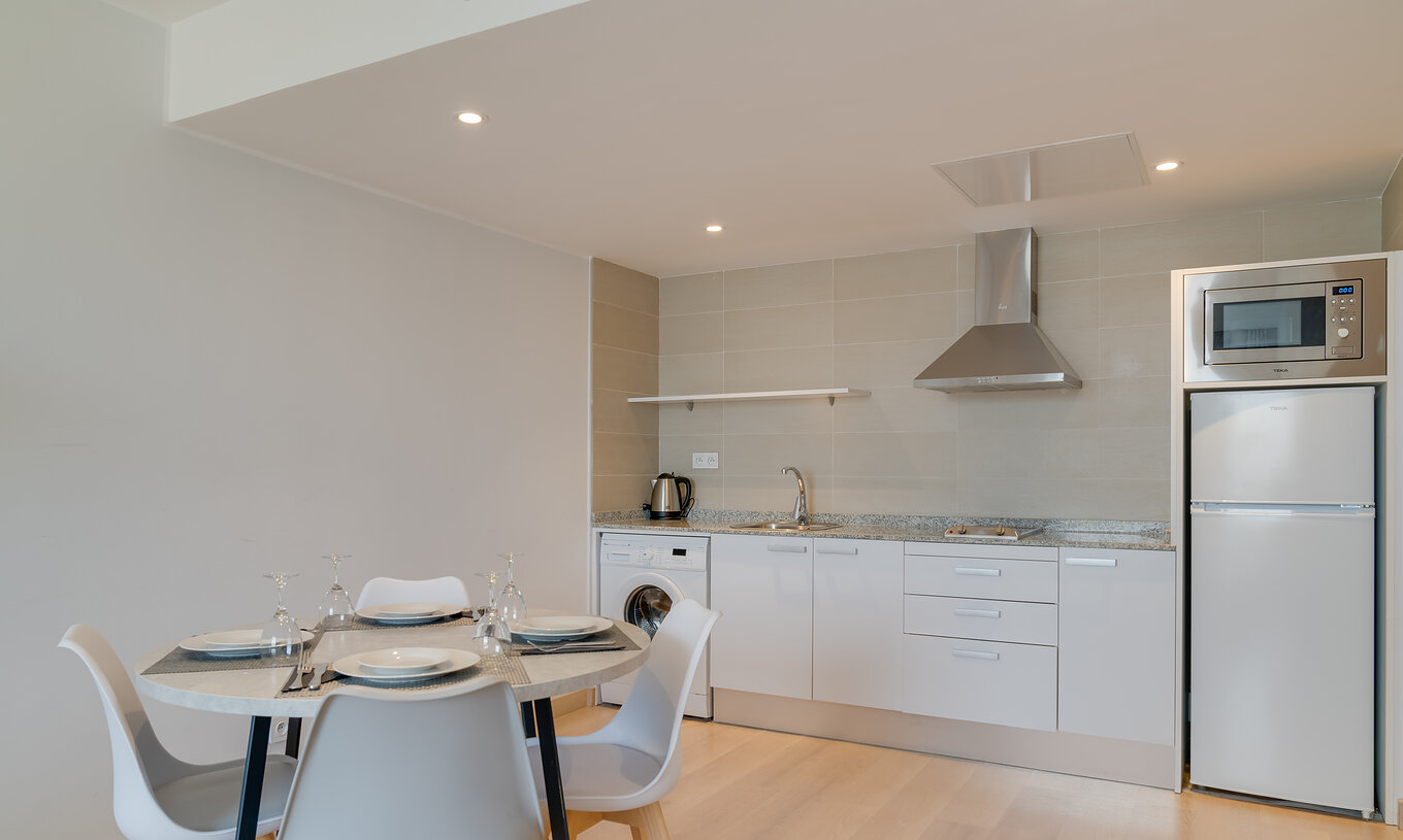 The Family Premium Suite of Pestana Tanger City Center features a kitchenette with stove, refrigerator, microwave, and table