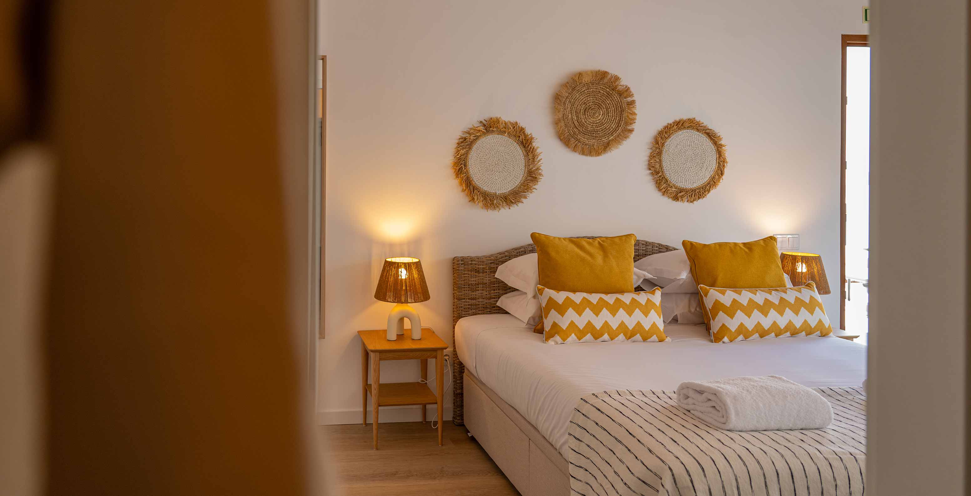 The Superior Villa at Pestana Comporta Village Residences has a bedroom with a double bed and yellow pillows