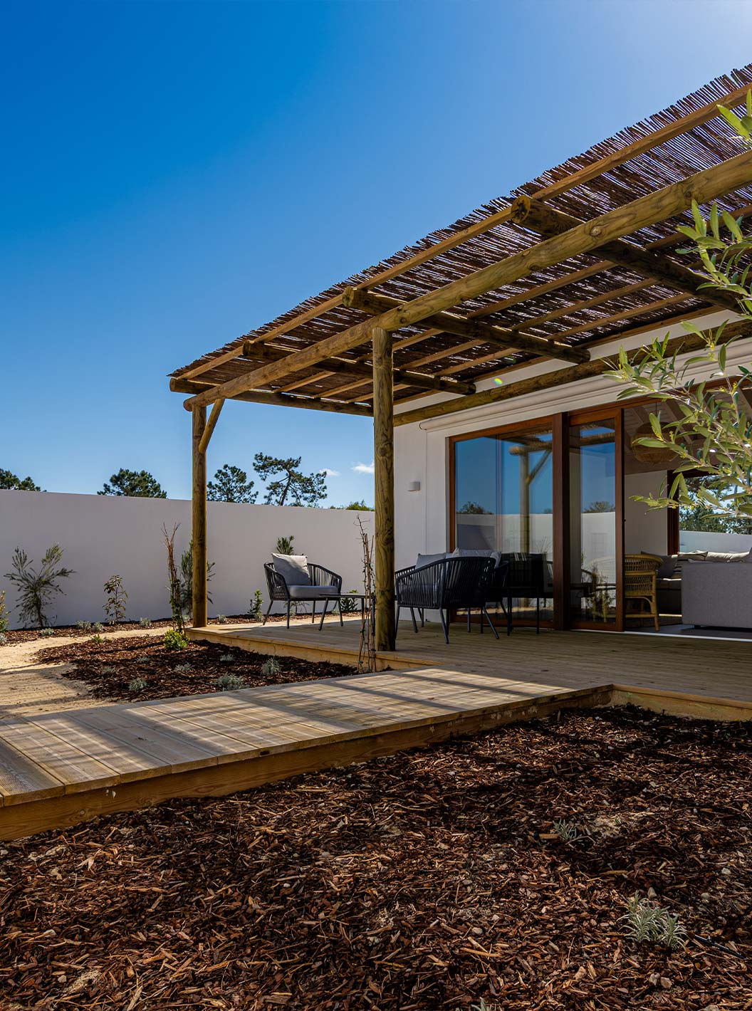 The Premium Green Villa at Pestana Comporta Village Residences has a deck patio with a wooden pergola for shade