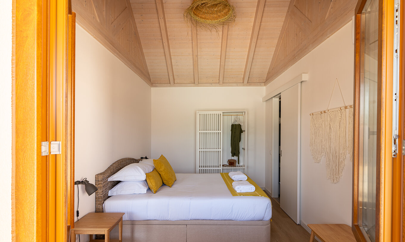 The Premium Villa at Pestana Comporta Village Residences has a bedroom with a double bed, pillows, and a white wardrobe