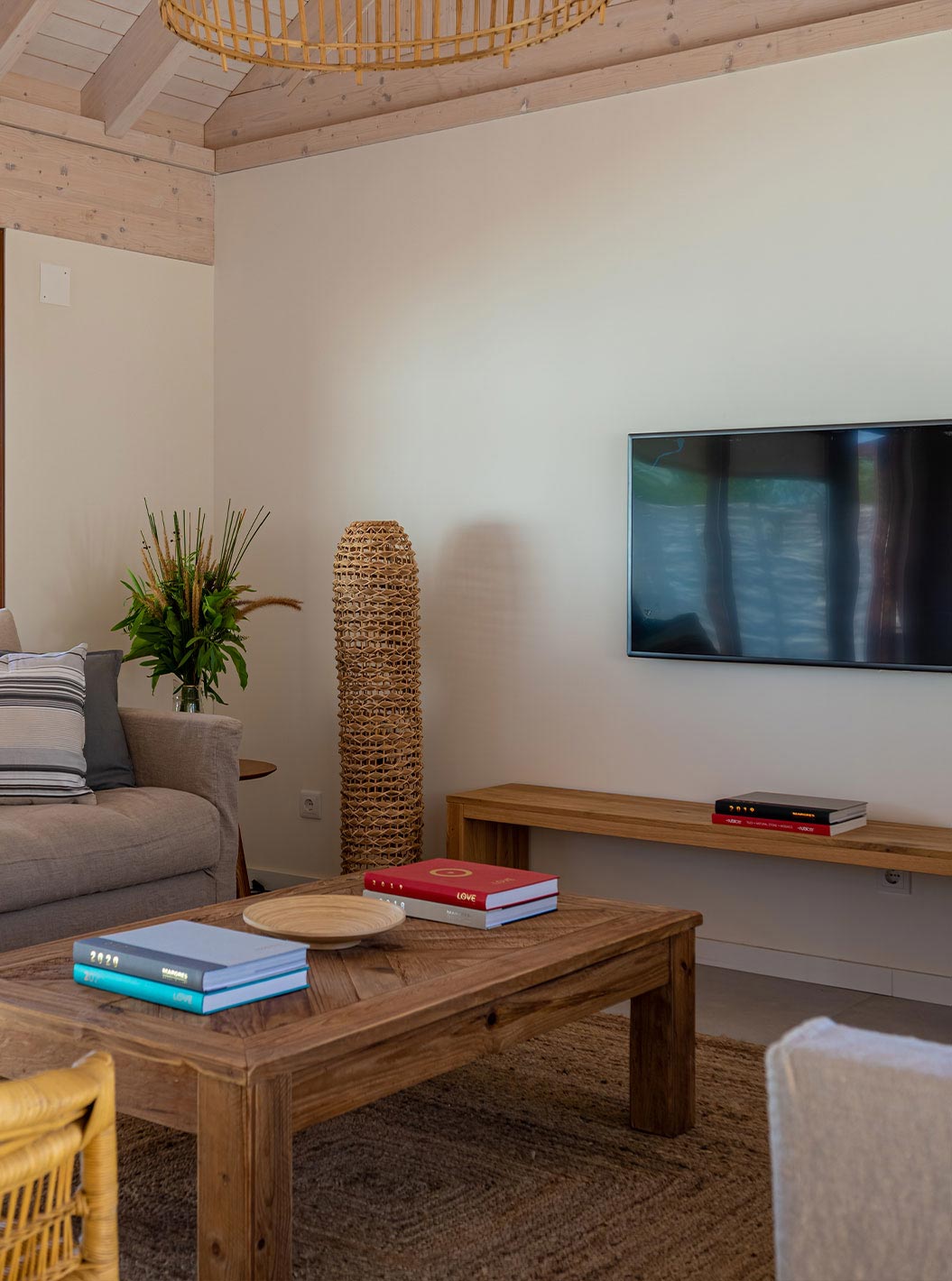 The Standard Villa T2 at Pestana Comporta Village Residences has a living room with a sofa and a TV on the wall
