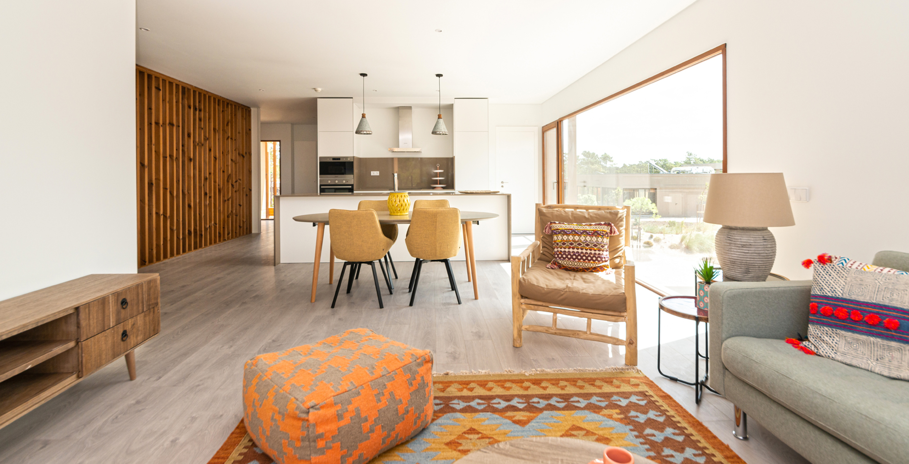 The Eco Village Apartment 1st Floor of Pestana Tróia Eco Resort has a room combined with the kitchen, sofa, and dining table