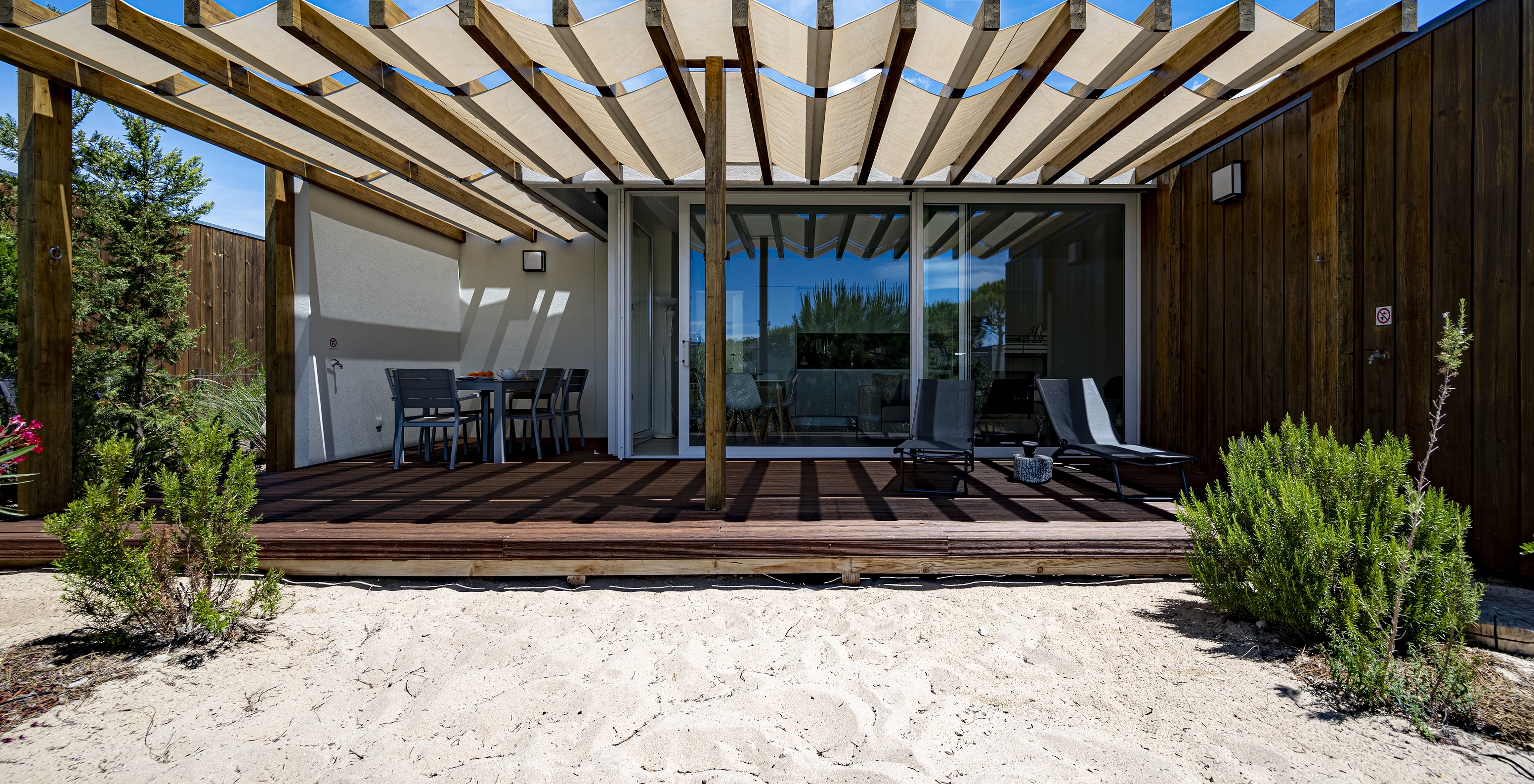 The Green Villa of Pestana Tróia Eco Resort has a terrace with two sun loungers and a table with chairs