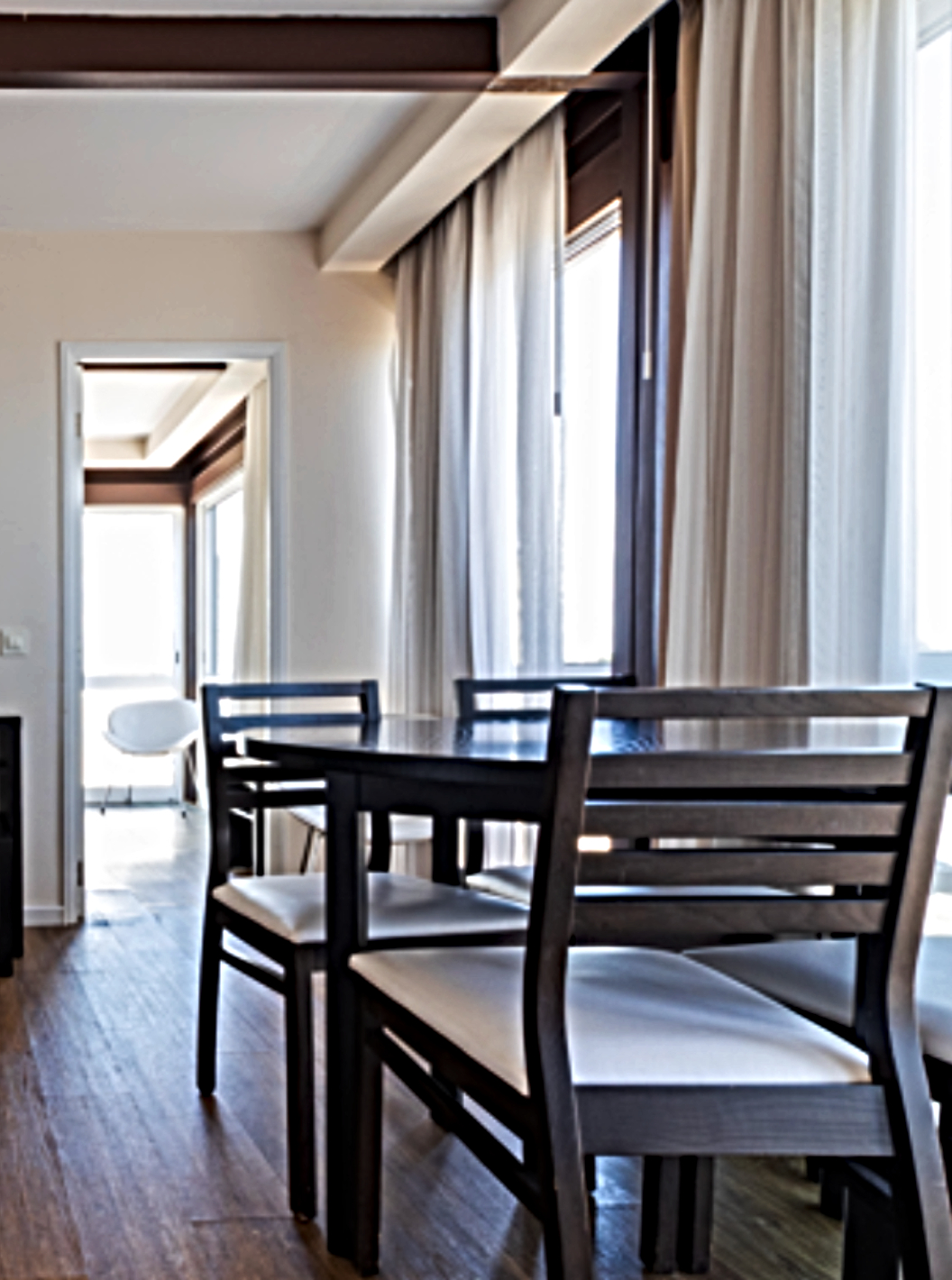 The Superior Sea View Studio at Pestana Alvor Atlântico offers a bright living area with a sofa, dining table and television, providing a cosy atmosphere with large windows that allow plenty of natural light in.