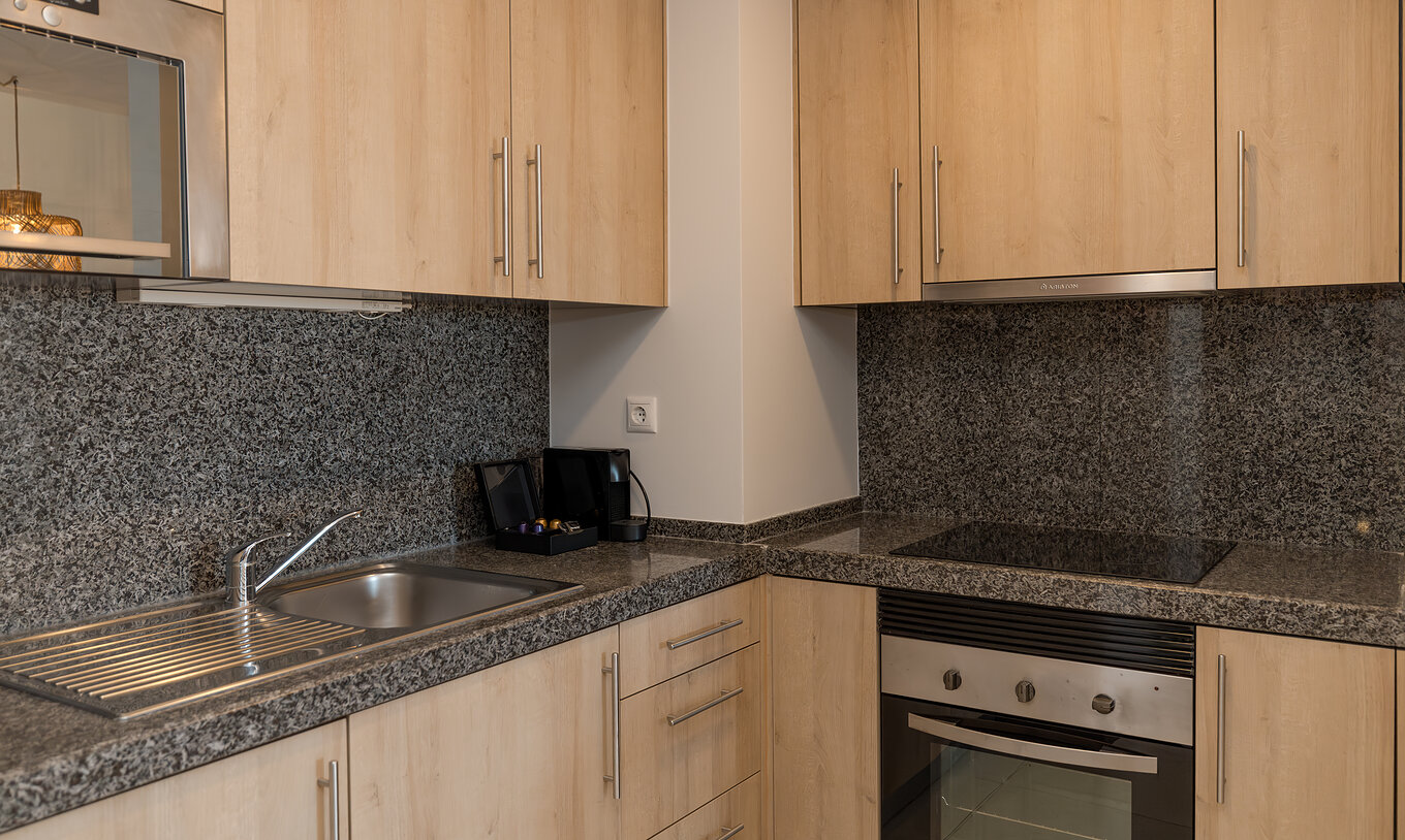 Apartment T1 Garden View at Pestana Alvor Beach Villas has a kitchen with stove, sink and coffee machine