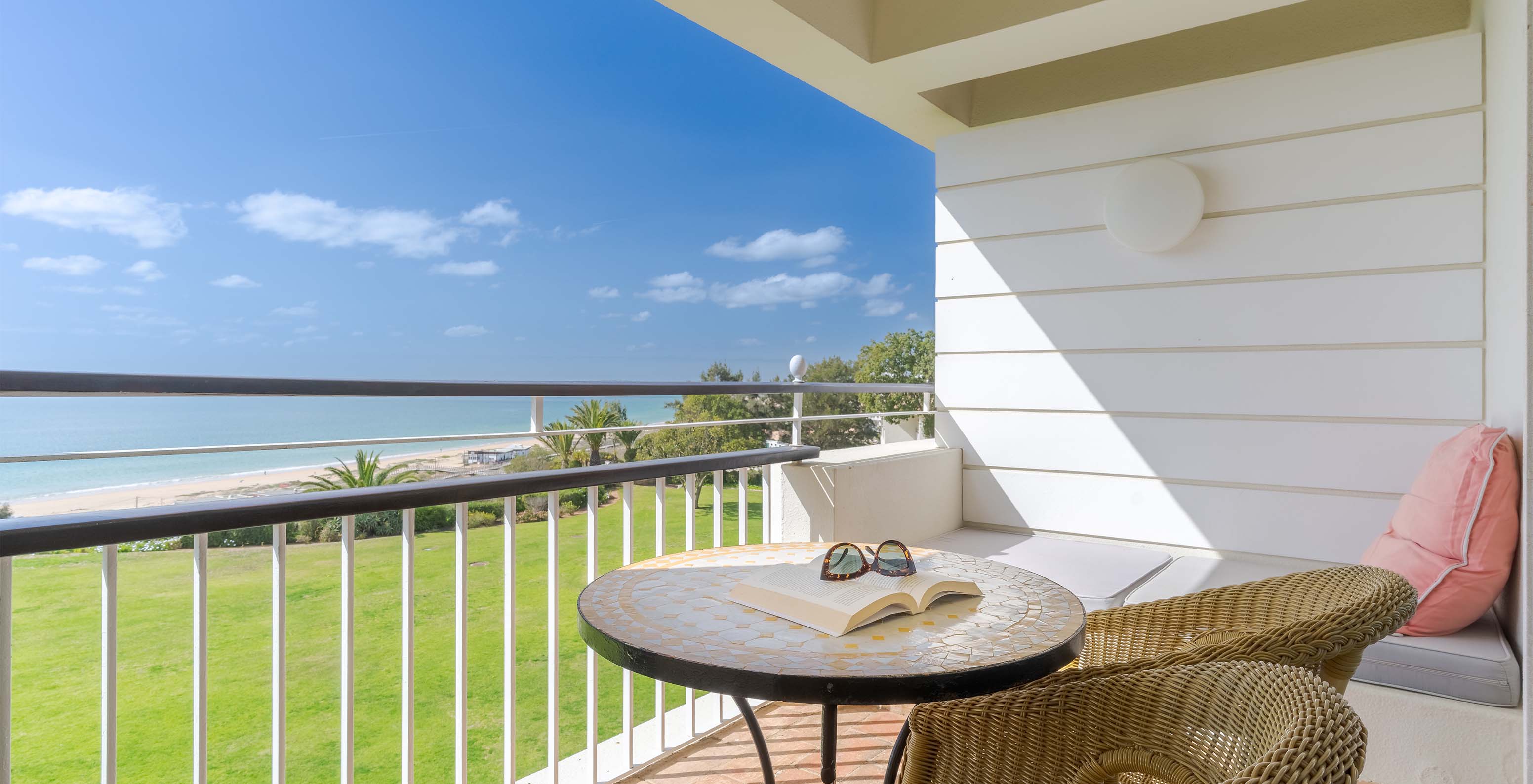 The Sea View Deluxe at Pestana Alvor Praia has a balcony with chairs, a table, and a sofa with sea views