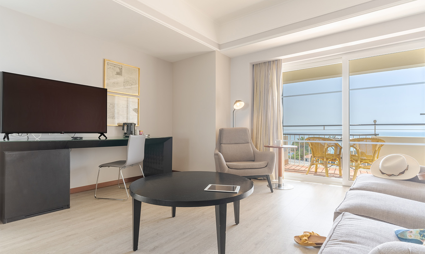 The Sea View Suite at Pestana Alvor Praia has a sofa with a coffee table, a desk with TV, and a sea view
