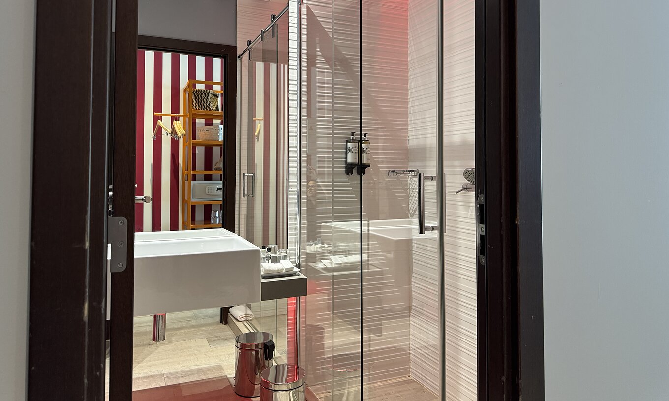 The Deluxe - Exclusive Website of Pestana Alvor South Beach has a bathroom with shower and a sink