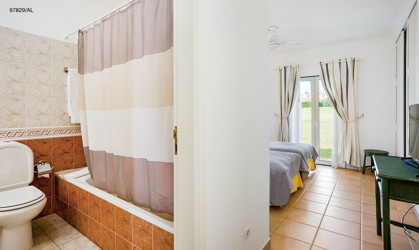 The Pestana Carvoeiro Golf T2 Standard Apartment has a bathroom with a bathtub and toilet