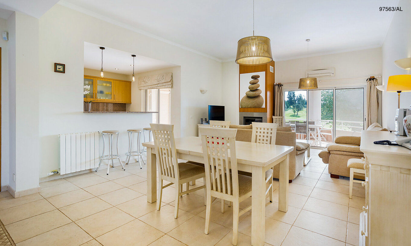 The Pestana Carvoeiro Golf T3 Superior Apartment has a dining room with a view of the kitchen, a table, and four chairs