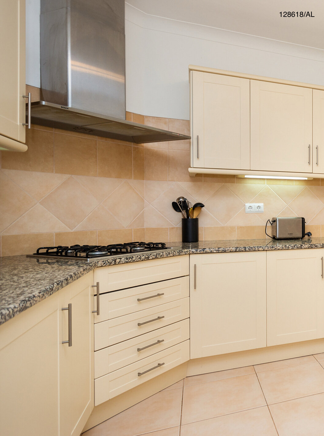 The Pestana Carvoeiro Golf V3 Superior Villa has a kitchen equipped with white cabinets and appliances