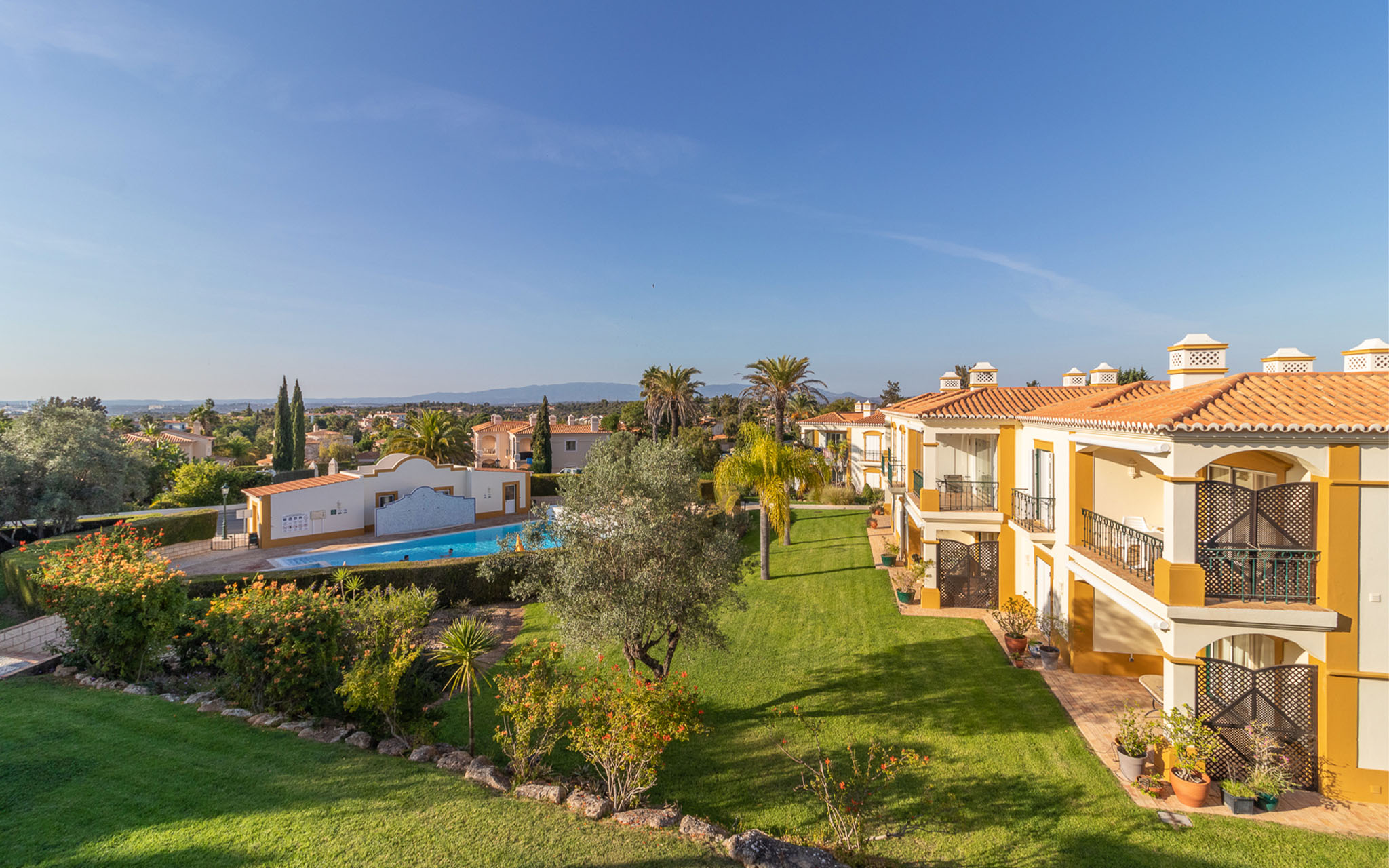 Exterior view of Pestana Carvoeiro Golf AL, a 4-star hotel in the Algarve, with villas, apartments, and an outdoor pool