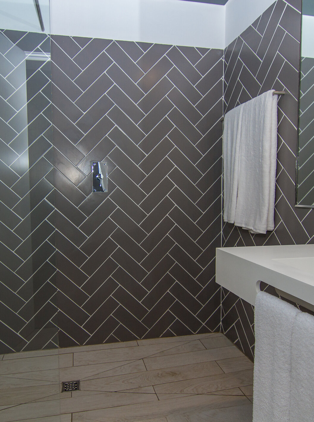 The Studio at Pestana Gramacho Residences has a bathroom with a walk-in shower, sink, mirror, and towels