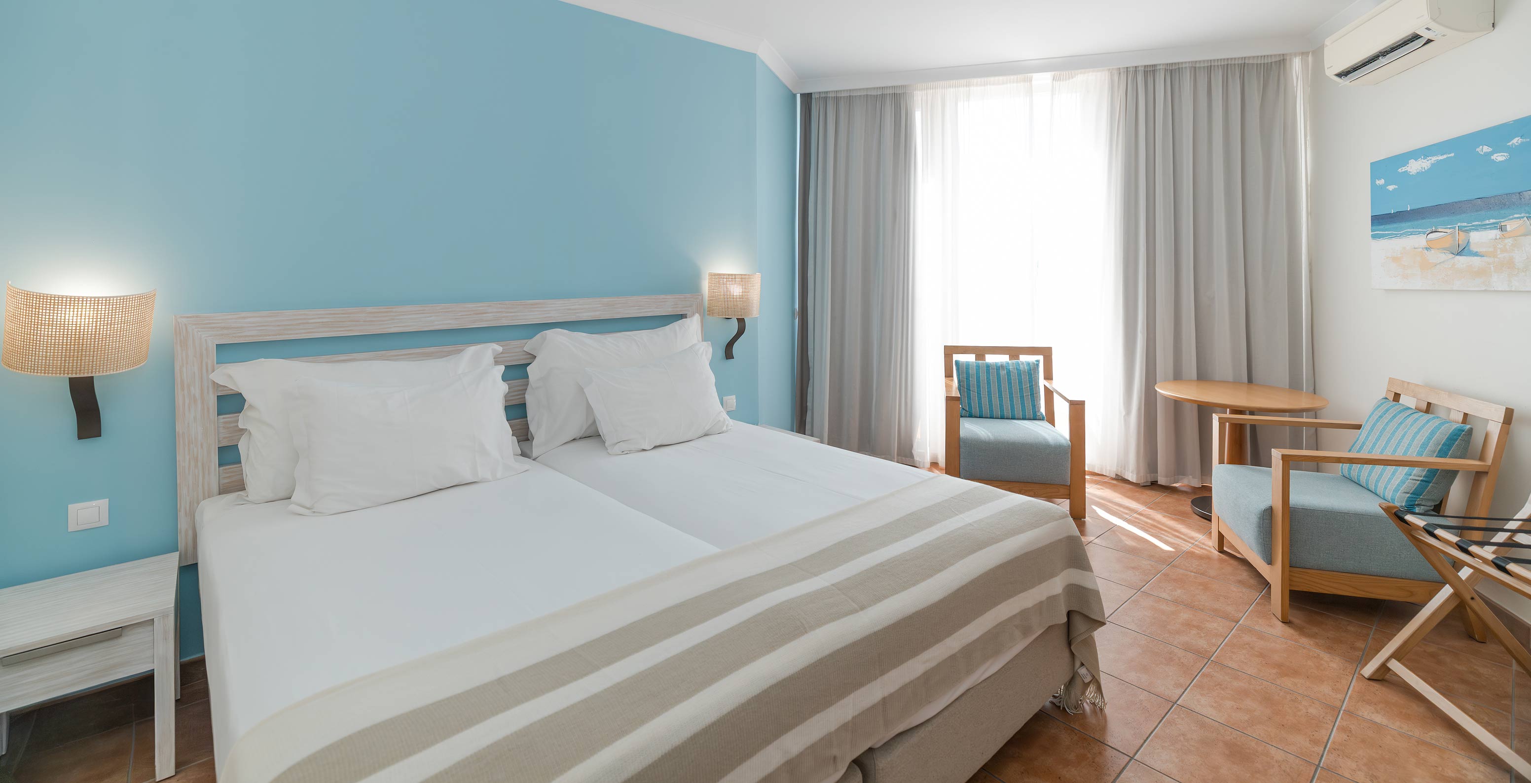 The Deluxe at Pestana Viking has two single beds, two comfy armchairs, air conditioning and large window