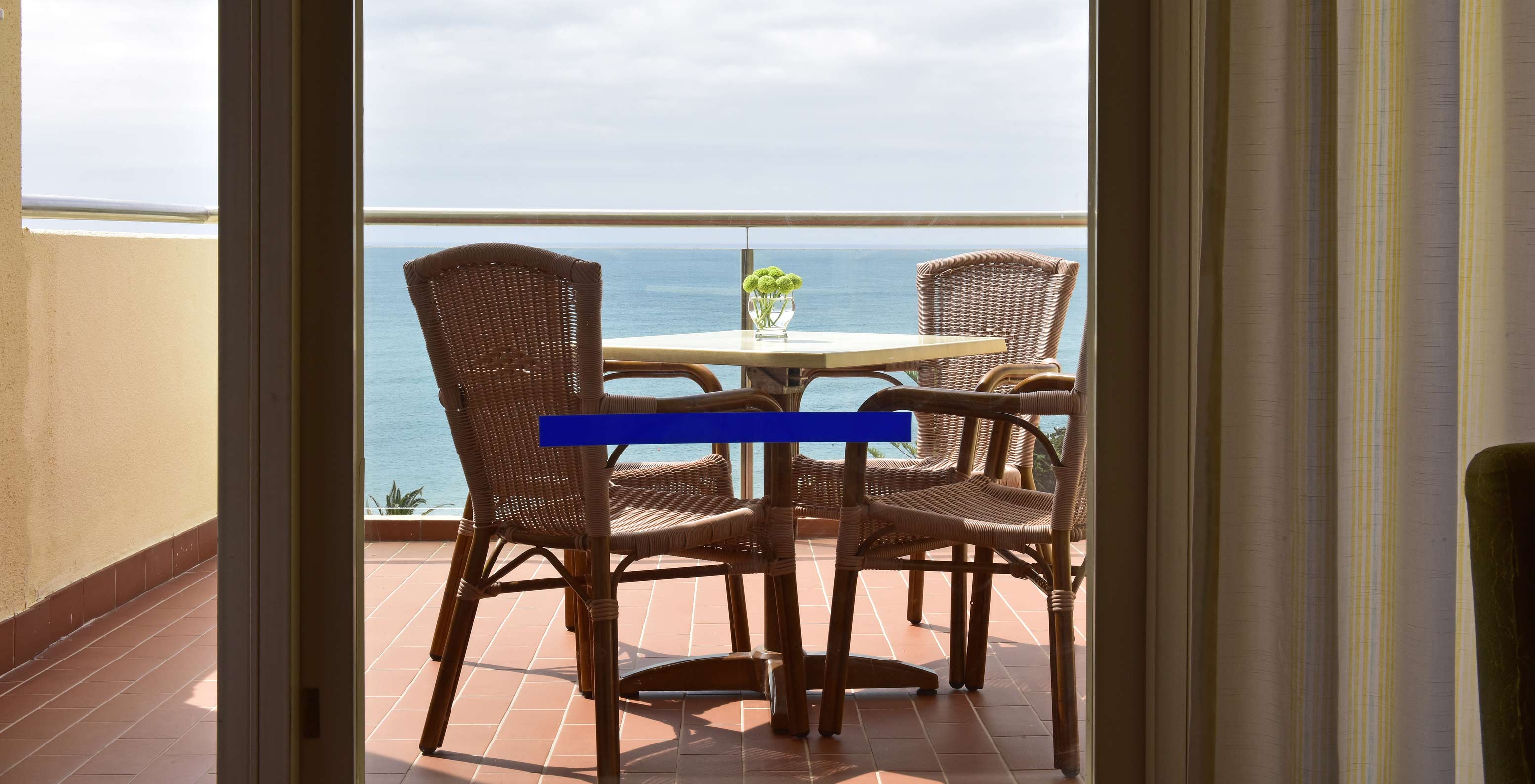 The Superior Sea View Suite at Pestana Viking features a balcony with a table and two chairs, and sea view