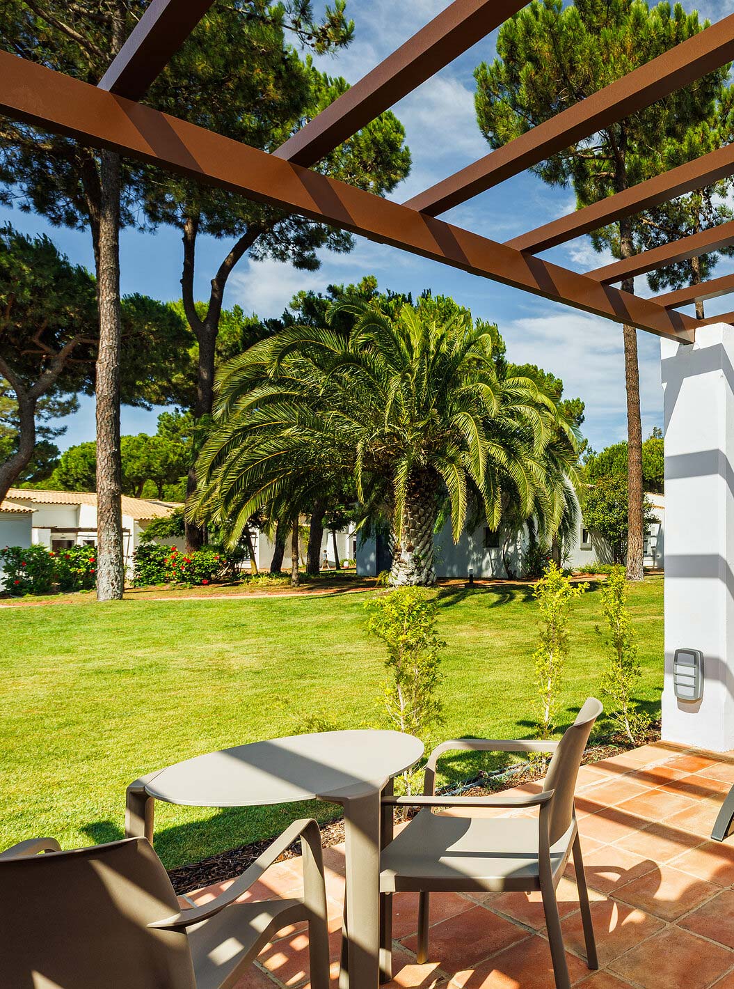 The Family Garden View at Pestana Vila Sol - Vilamoura has a balcony with sun lounger, table and garden view