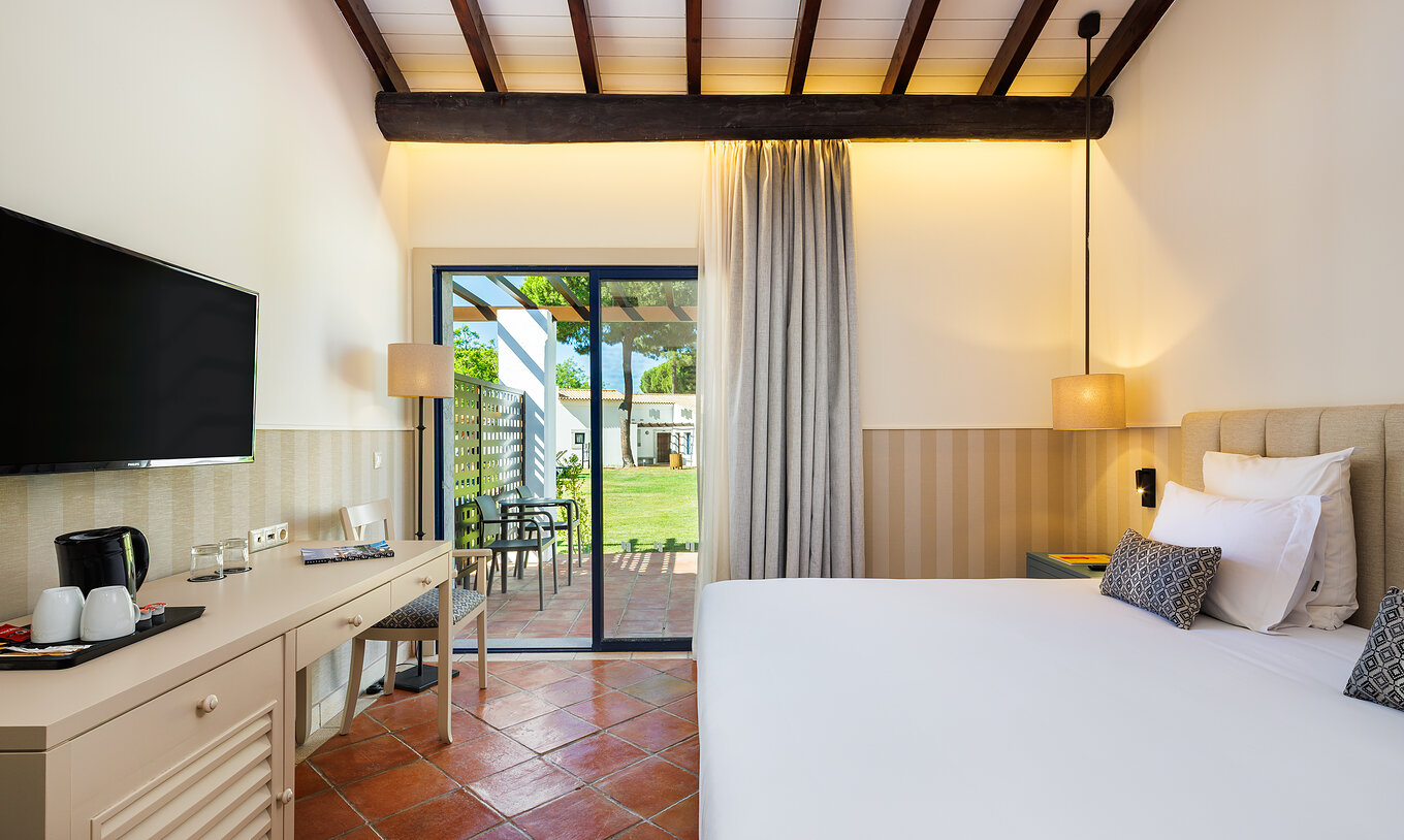The Superior Garden View at Pestana Vila Sol - Vilamoura has a double bed, TV and window with balcony access