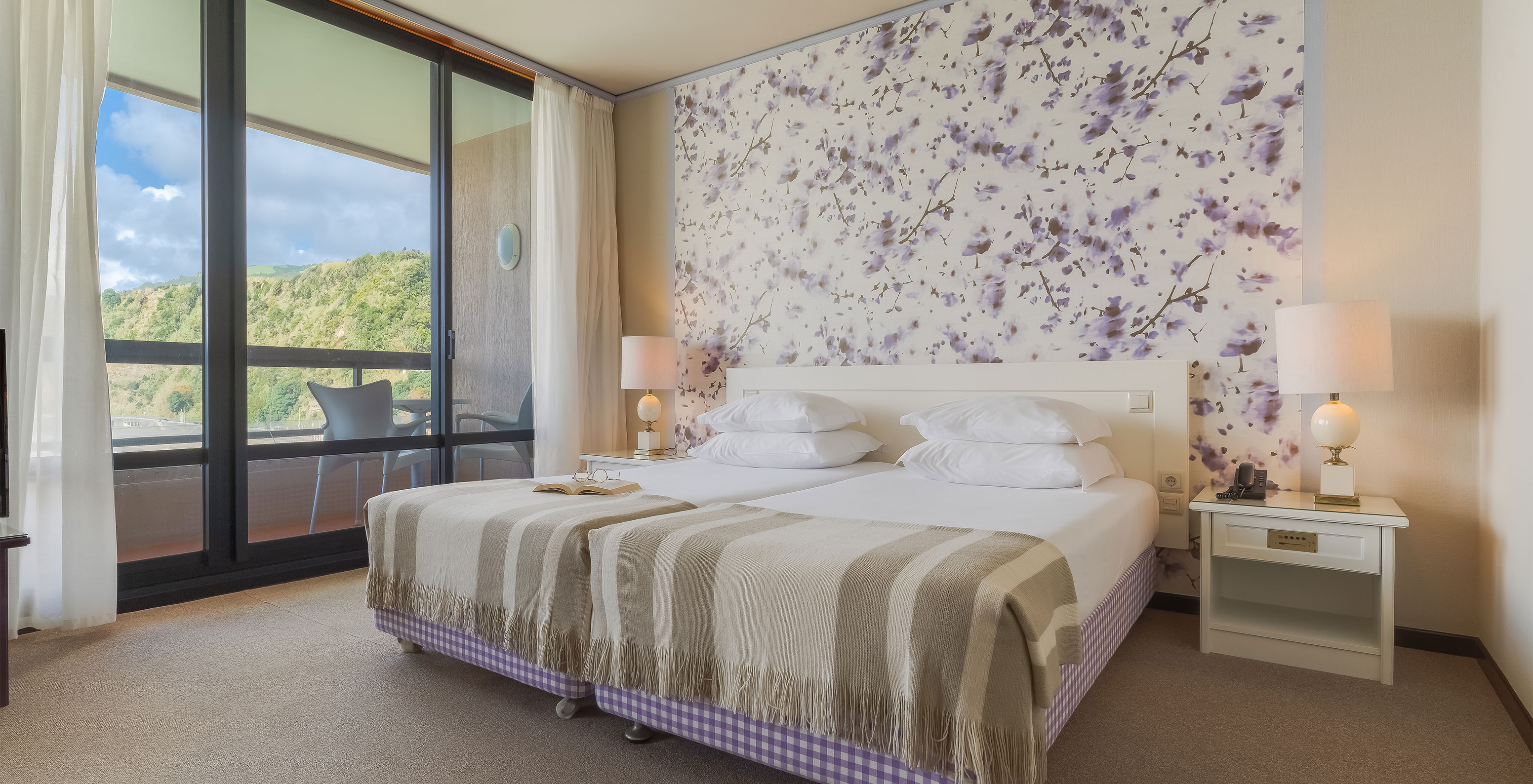 Junior Sea View Suite at Pestana Bahia Praia has a spacious area with two single beds, a sofa and a chair