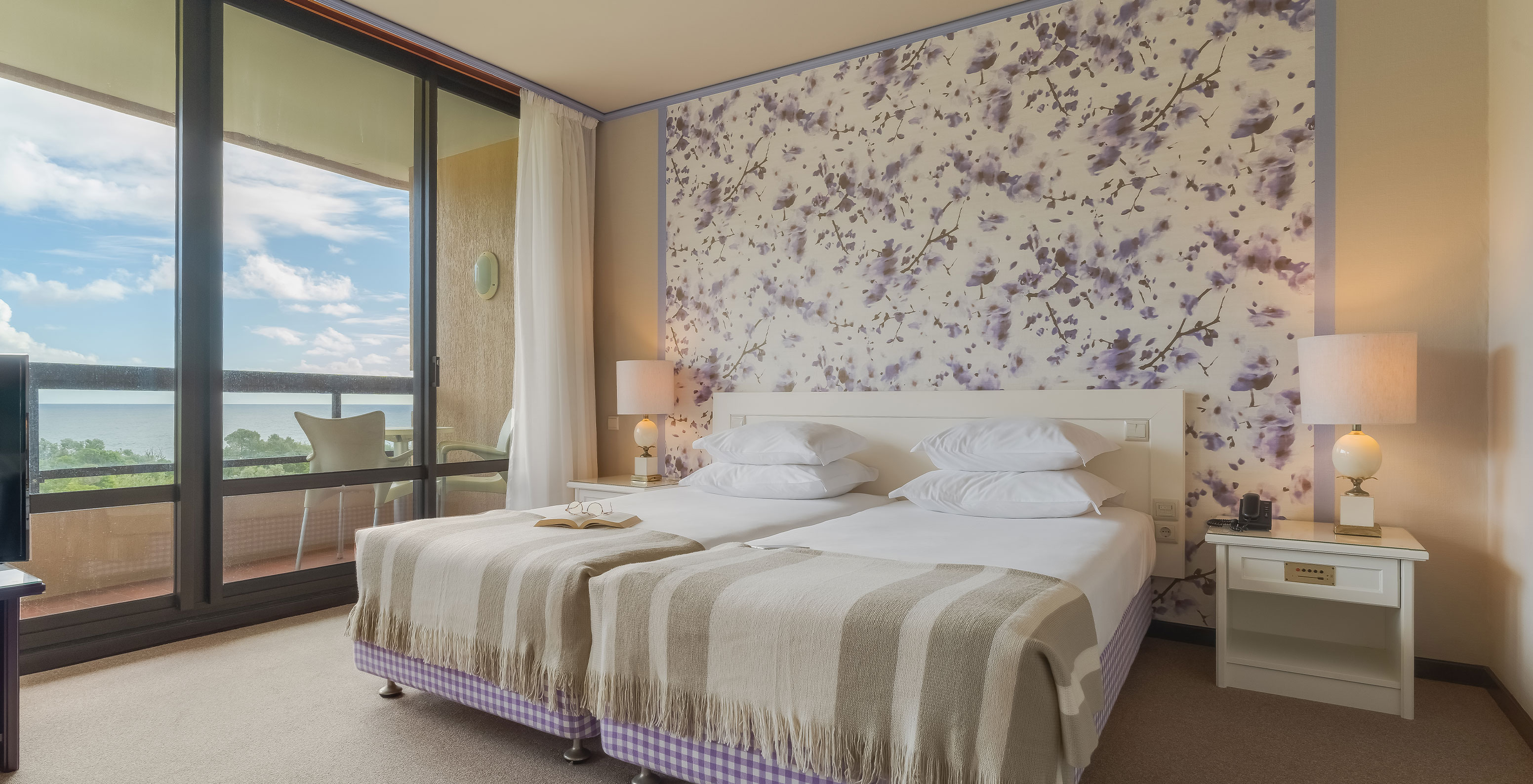 Junior Garden View Suite at Pestana Bahia Praia has a spacious area with two single beds, a sofa and a chair