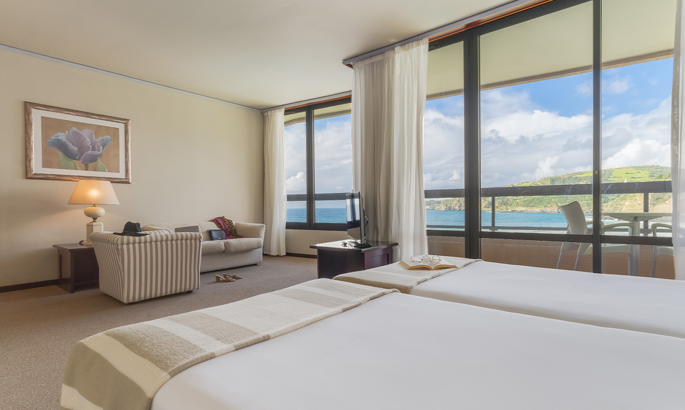 Junior Sea View Suite at Pestana Bahia Praia has a beautiful view of green landscapes and the sea, with access to the balcony