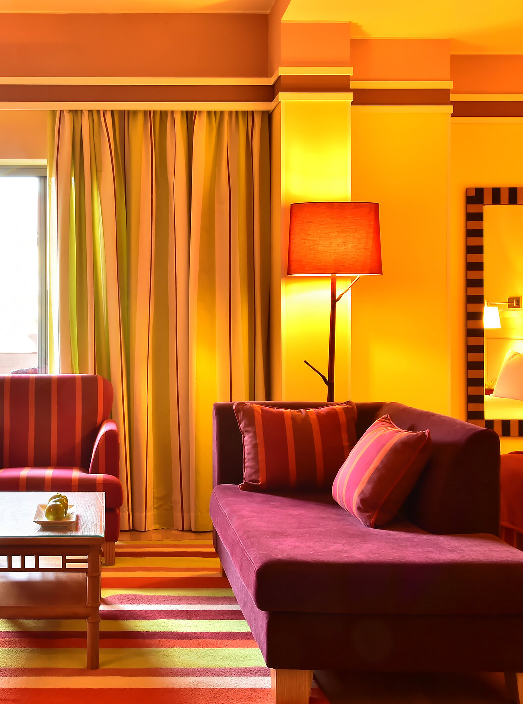 The Junior Suite of Pestana Sintra Golf has two sofas, a coffee table, and a window with access to the balcony