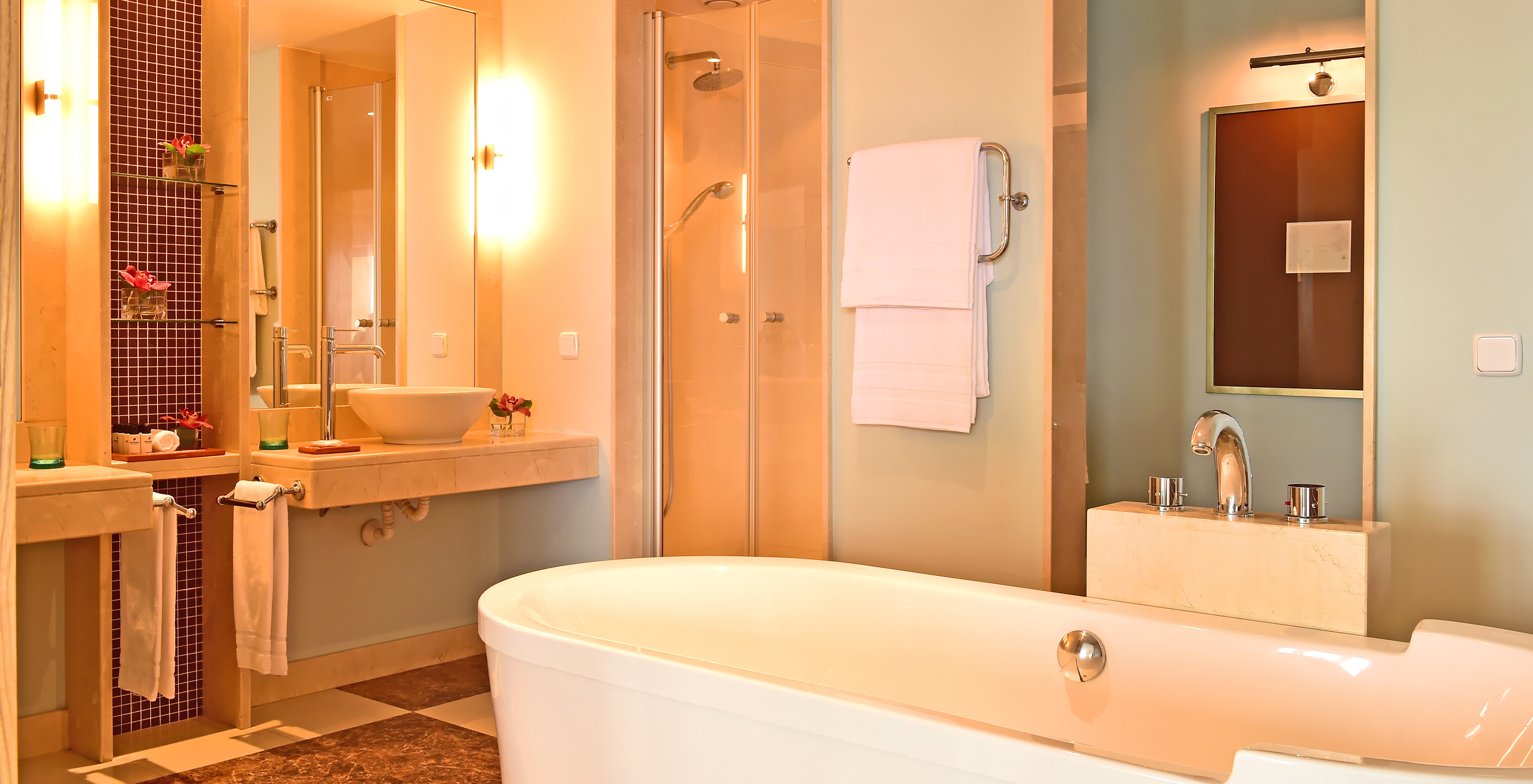 The Superior Junior Suite at Pestana Carlton Madeira has a bathroom with a bathtub, sink, and decorative elements