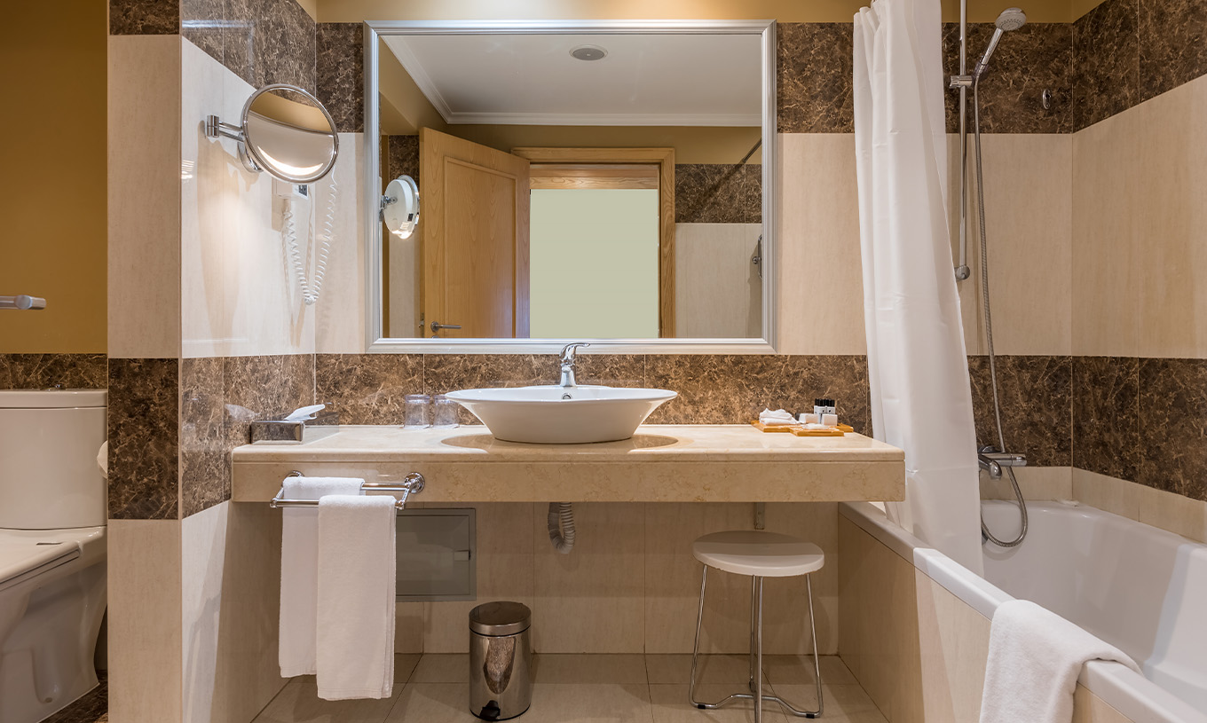 The Suite at Pestana Carlton Madeira has a tiled bathroom, a bathtub, and a toilet