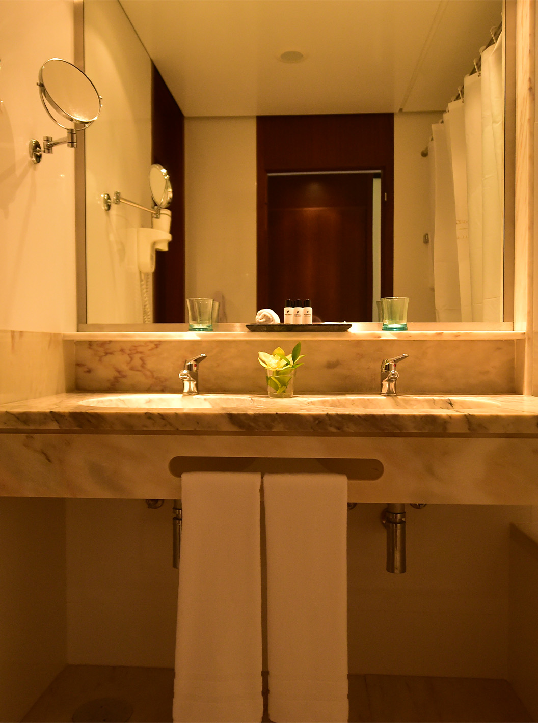 The Classic Garden View room at Pestana Casino Park has a bathroom with a marble sink, bathtub, and hairdryer