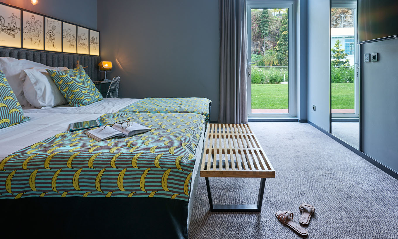 The CR7 Room at Pestana CR7 Funchal offers direct access to the hotel's upper garden through a glass door