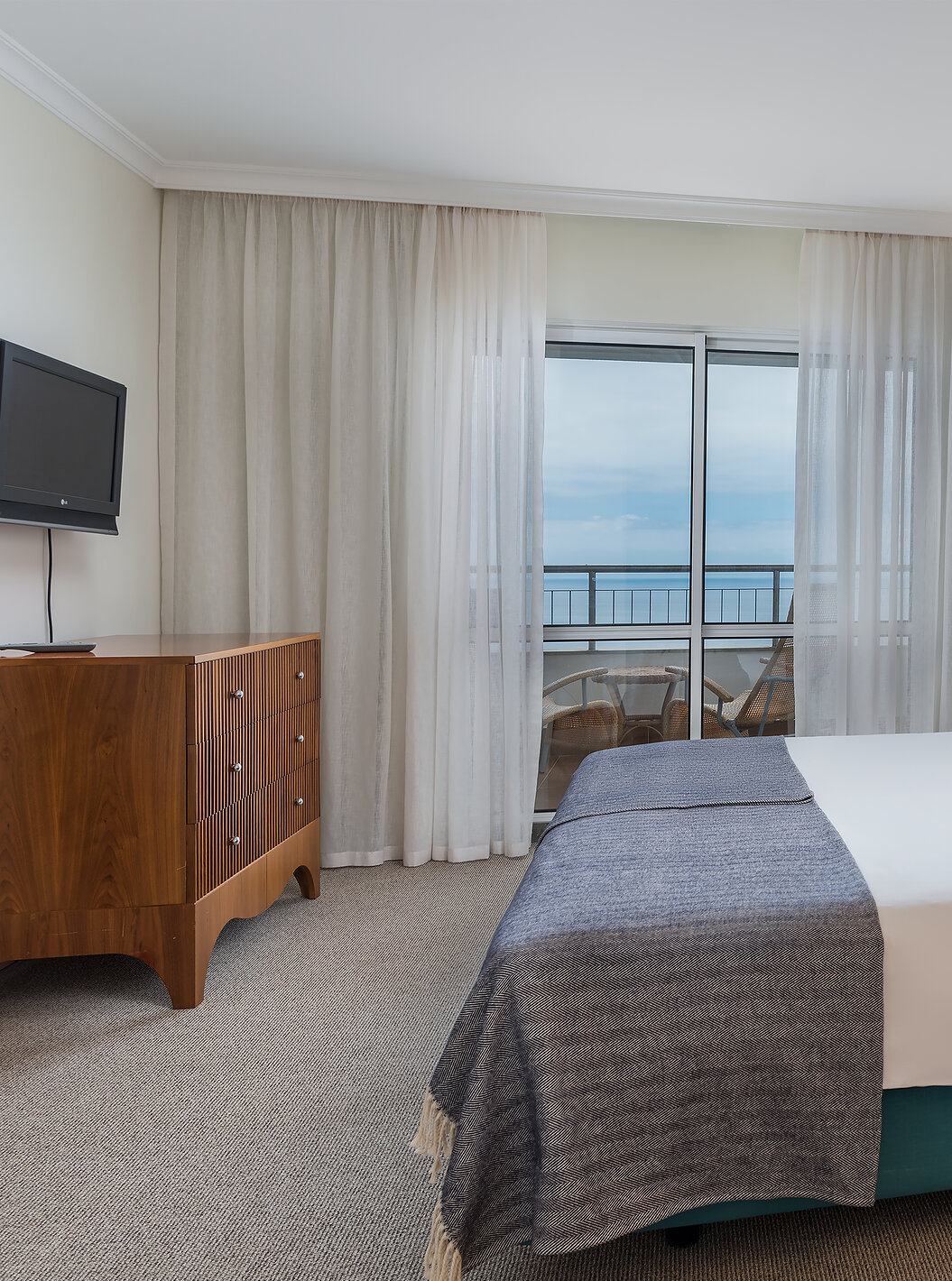 The Master Suite Sea View at Pestana Grand has a double bed with TV and balcony