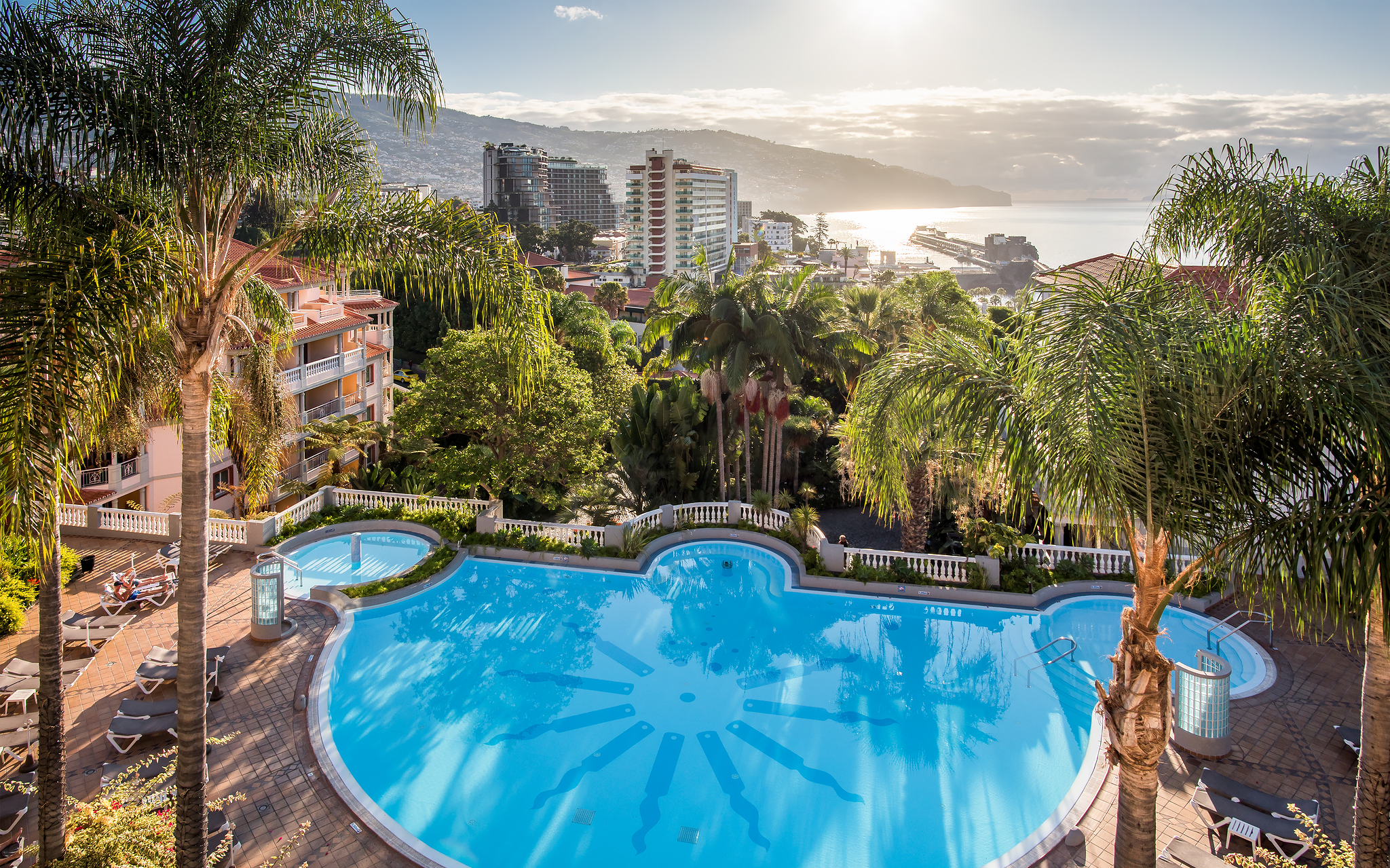 Aerial view of the pool at Pestana Miramar, a hotel in Madeira near the beach, surrounded by palm trees