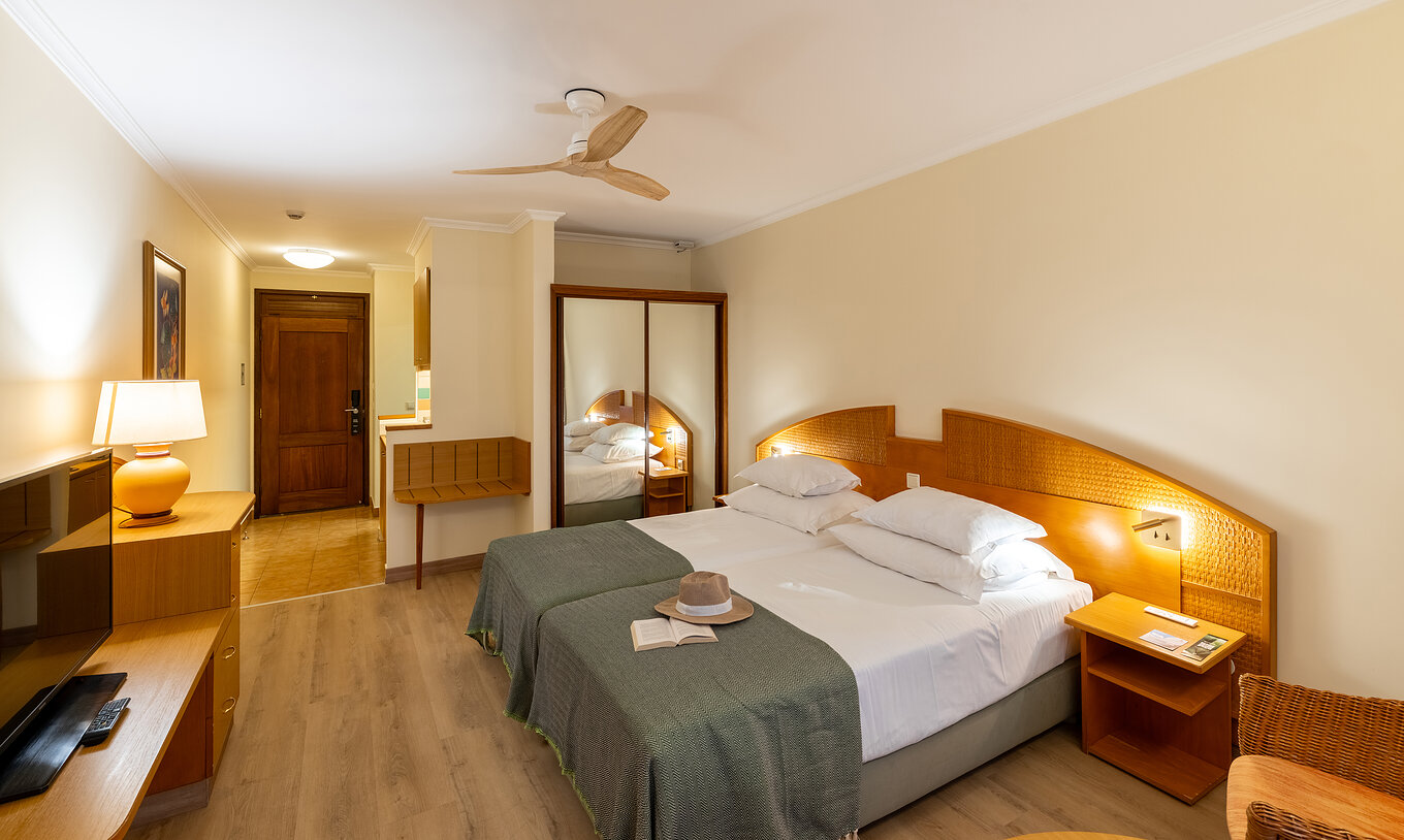 The Pestana Ocean Bay All Inclusive Classic Pool View has two single beds joined together with a green bedspread