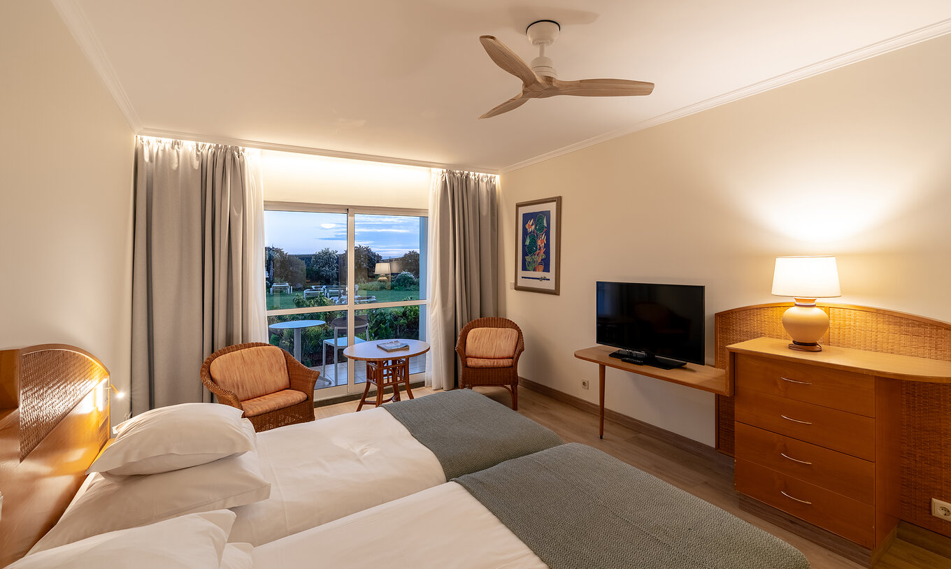 The Pestana Ocean Bay All Inclusive Classic Pool View has two single beds joined together, a garden view, and a TV cabinet