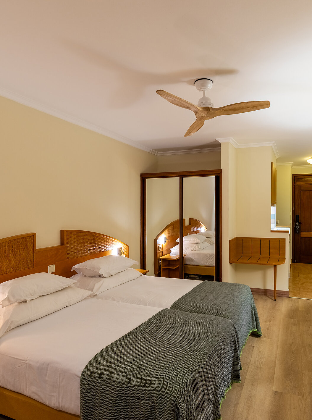 The Pestana Ocean Bay All Inclusive Superior Sea View has a double bed, a TV cabinet, a luggage rack, and a mirror