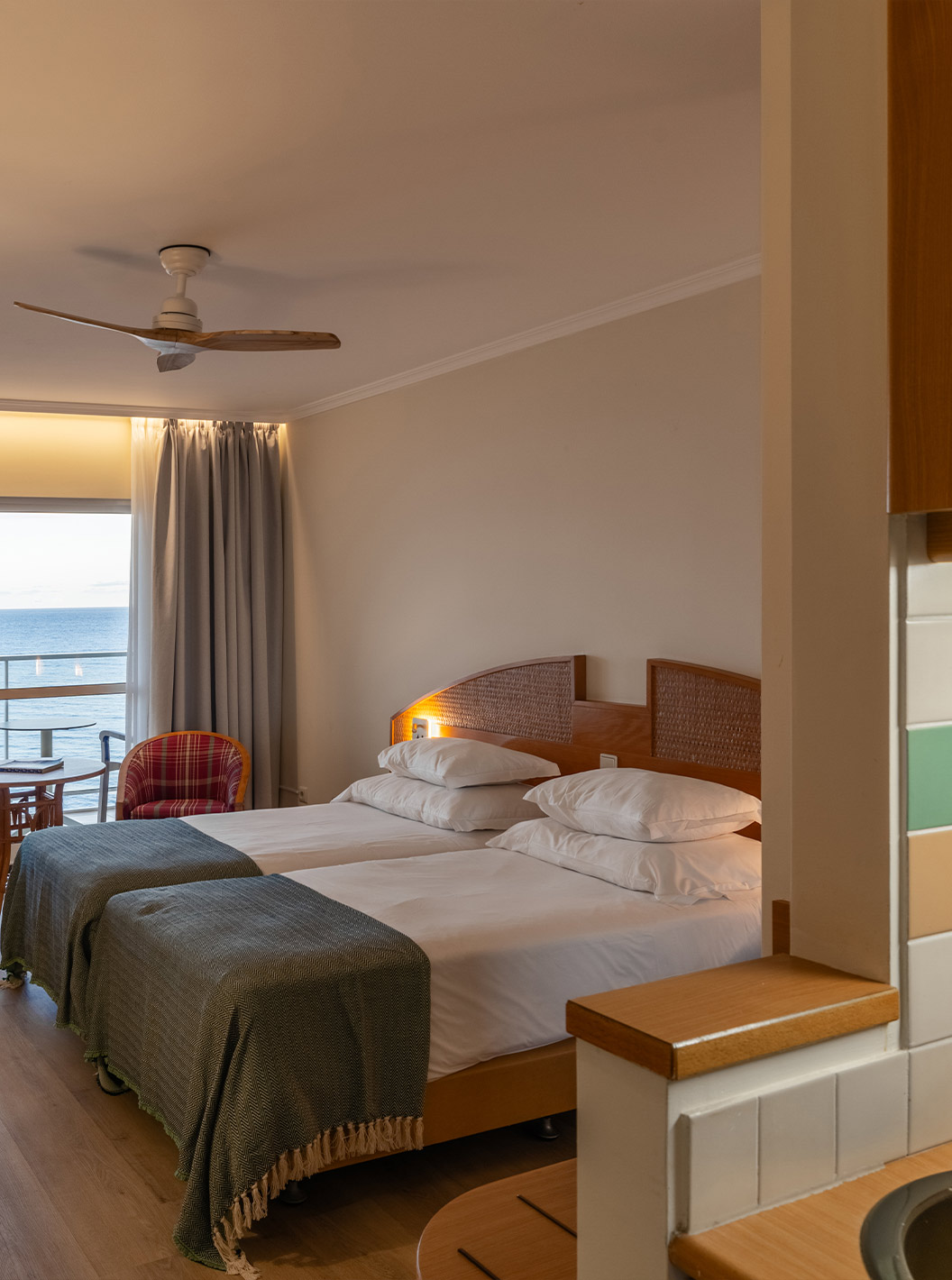 The Pestana Ocean Bay All Inclusive Superior Sea View has a double bed, two armchairs, and a balcony with sea view