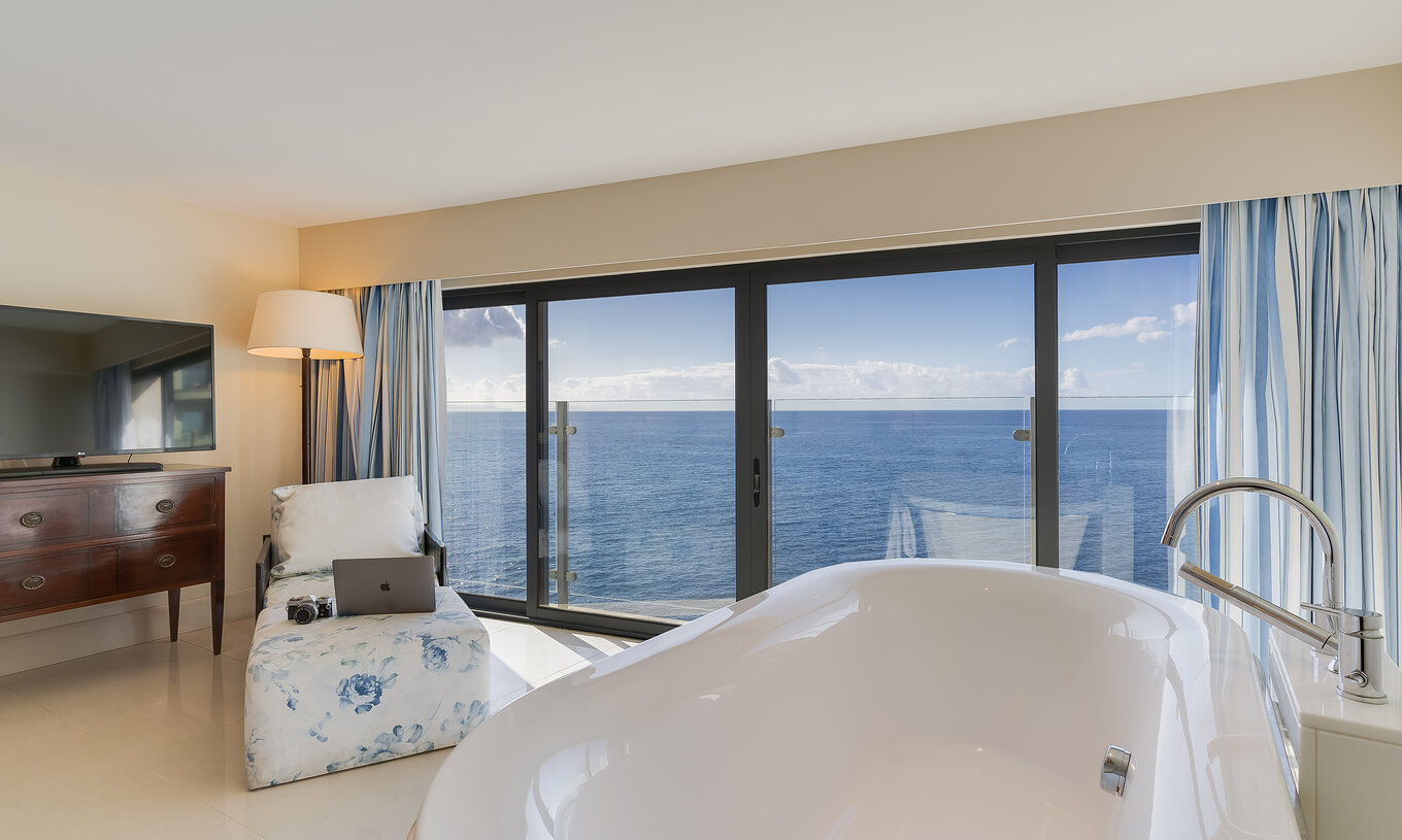 The Duplex Sea View Suite at Pestana Vila Lido Madeira features a bathtub with sea view and a chaise longue